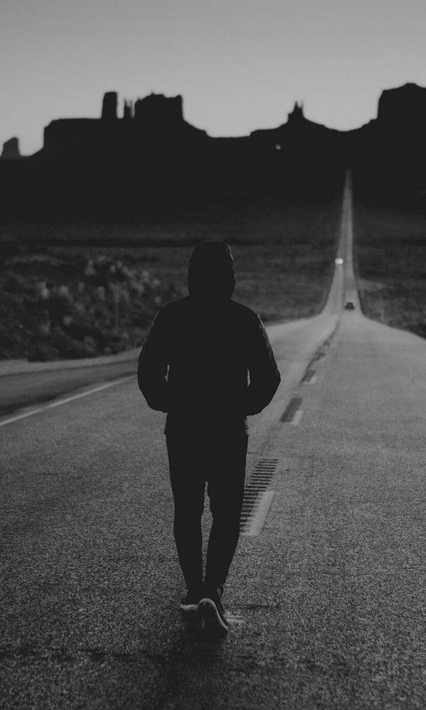 Single Boy, desert road, distant rock formations, SD Phone Wallpaper