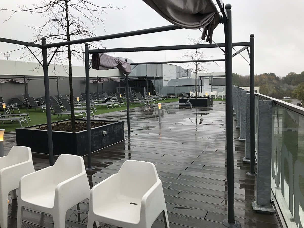 Sittard, rainy outdoor seating area, white chairs, SD Desktop Wallpaper