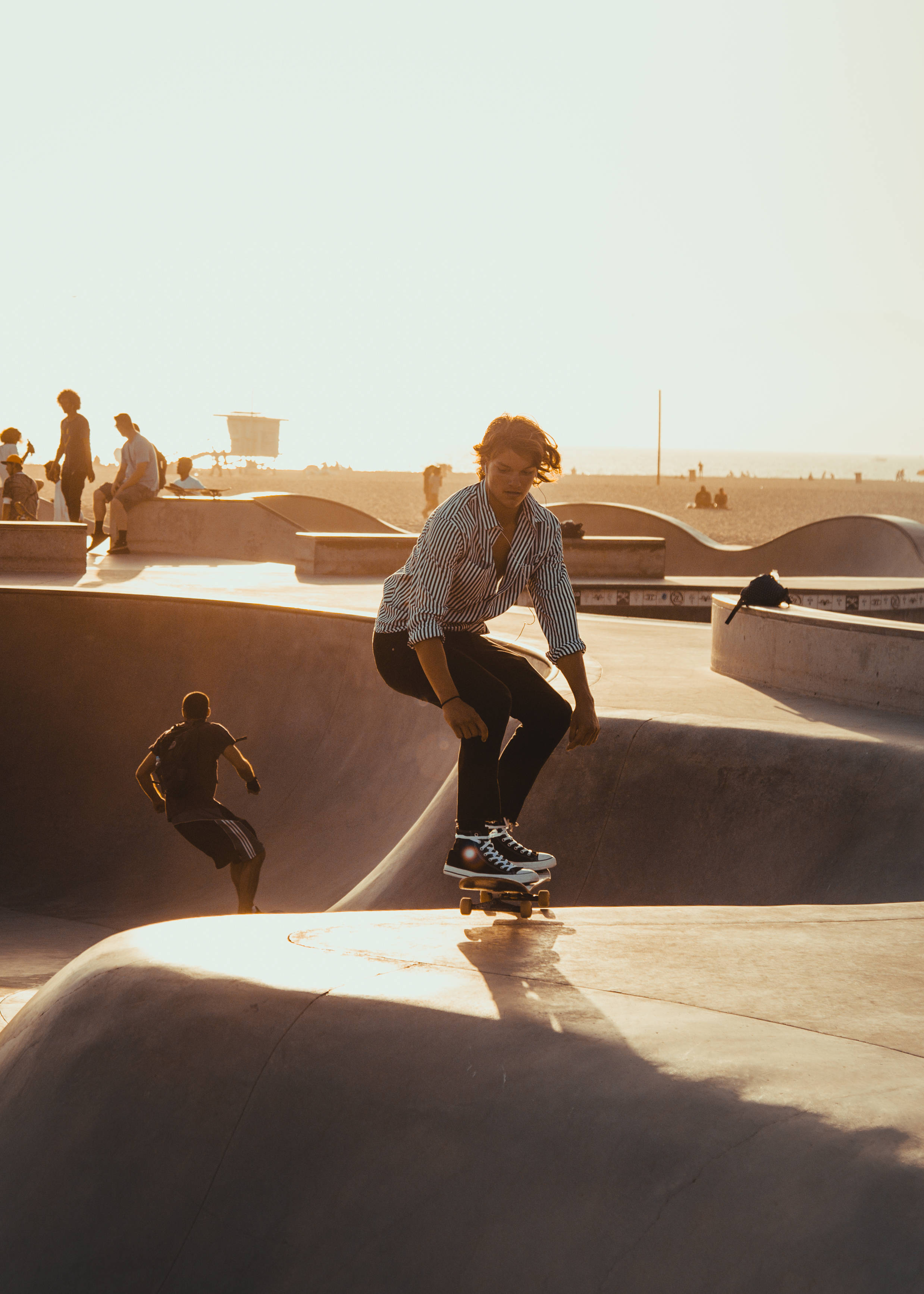 concrete bowl, coastal skatepark, golden sunlight, 2K Phone Wallpaper