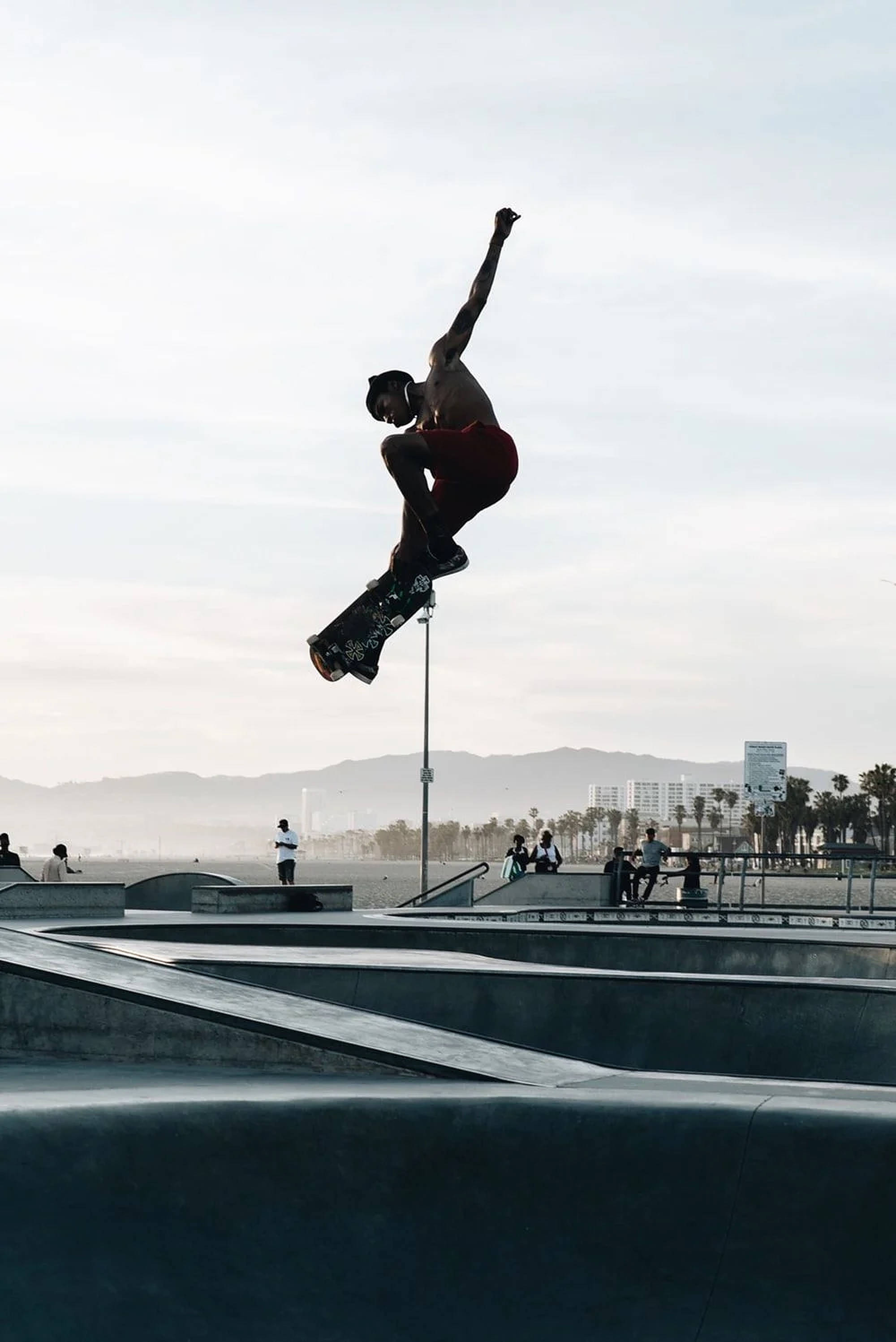 Skater Boy, mid-air, concrete skatepark, 2K Phone Wallpaper