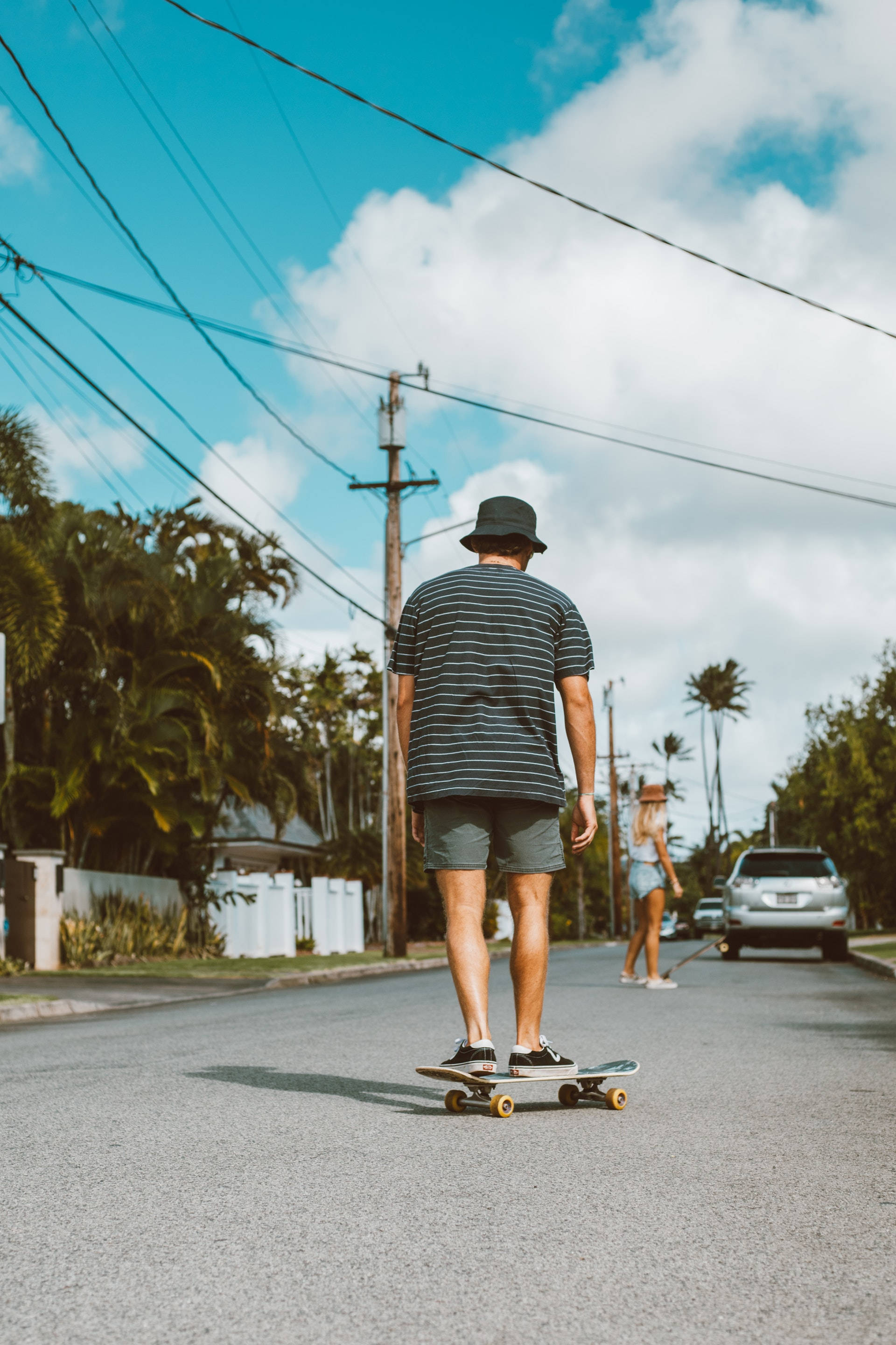 Skater Boy Aesthetic, palm tree-lined street, bright blue sky, 2K Phone Wallpaper