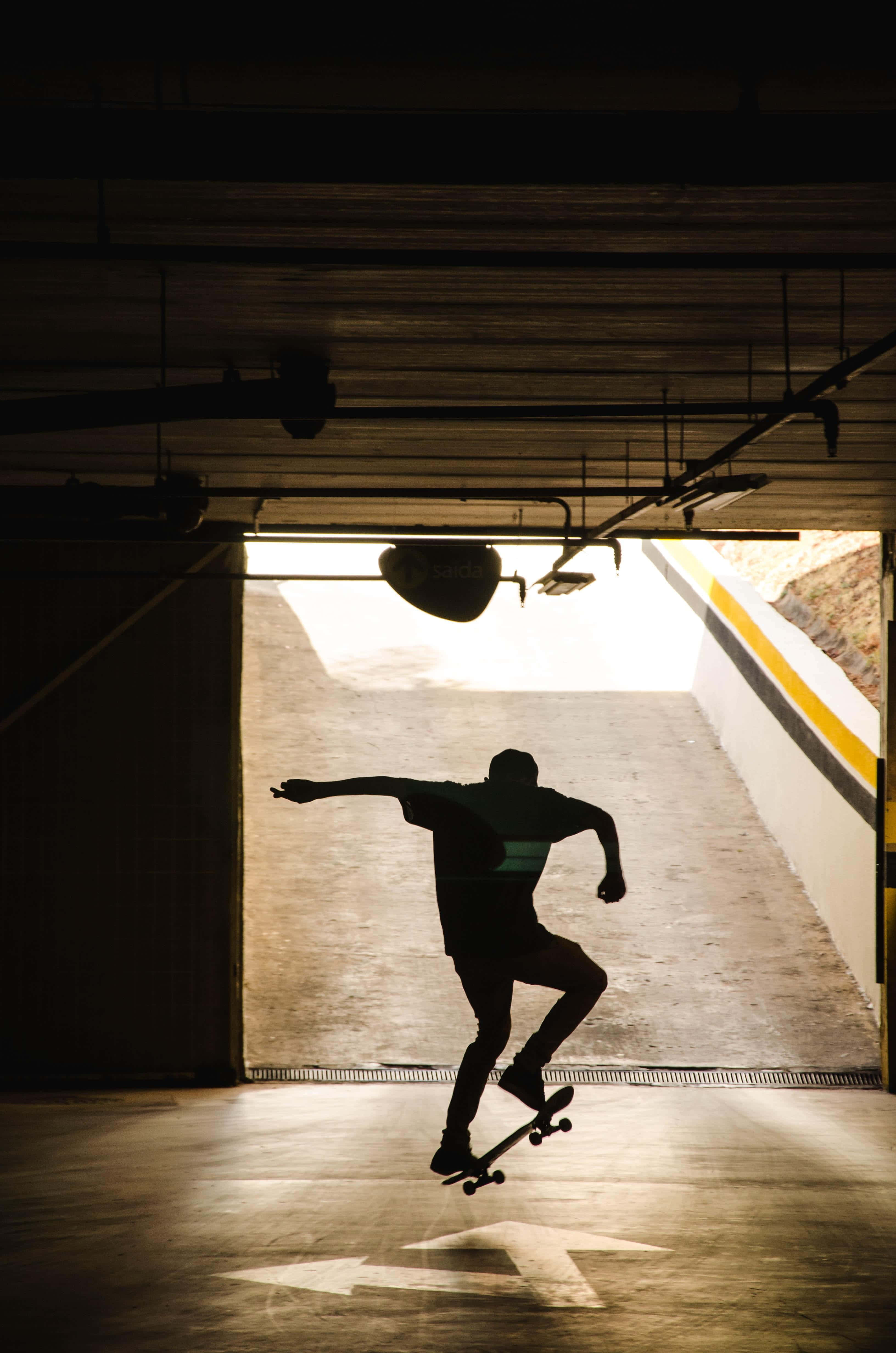 skateboarder, silhouette, dimly lit parking garage, 4K Phone Wallpaper
