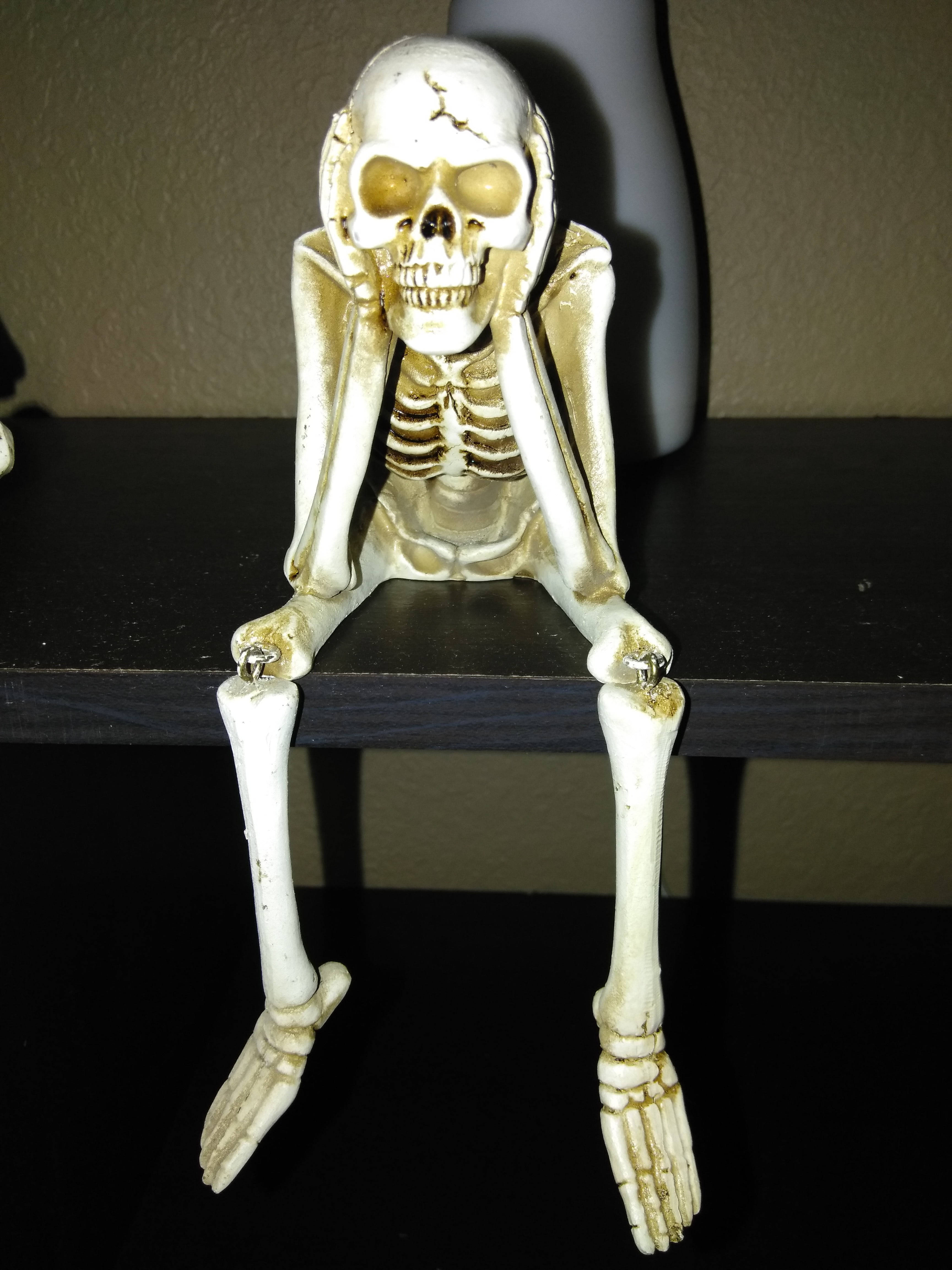 skeleton figurine, dark shelf, hands covering face, 4K Phone Wallpaper