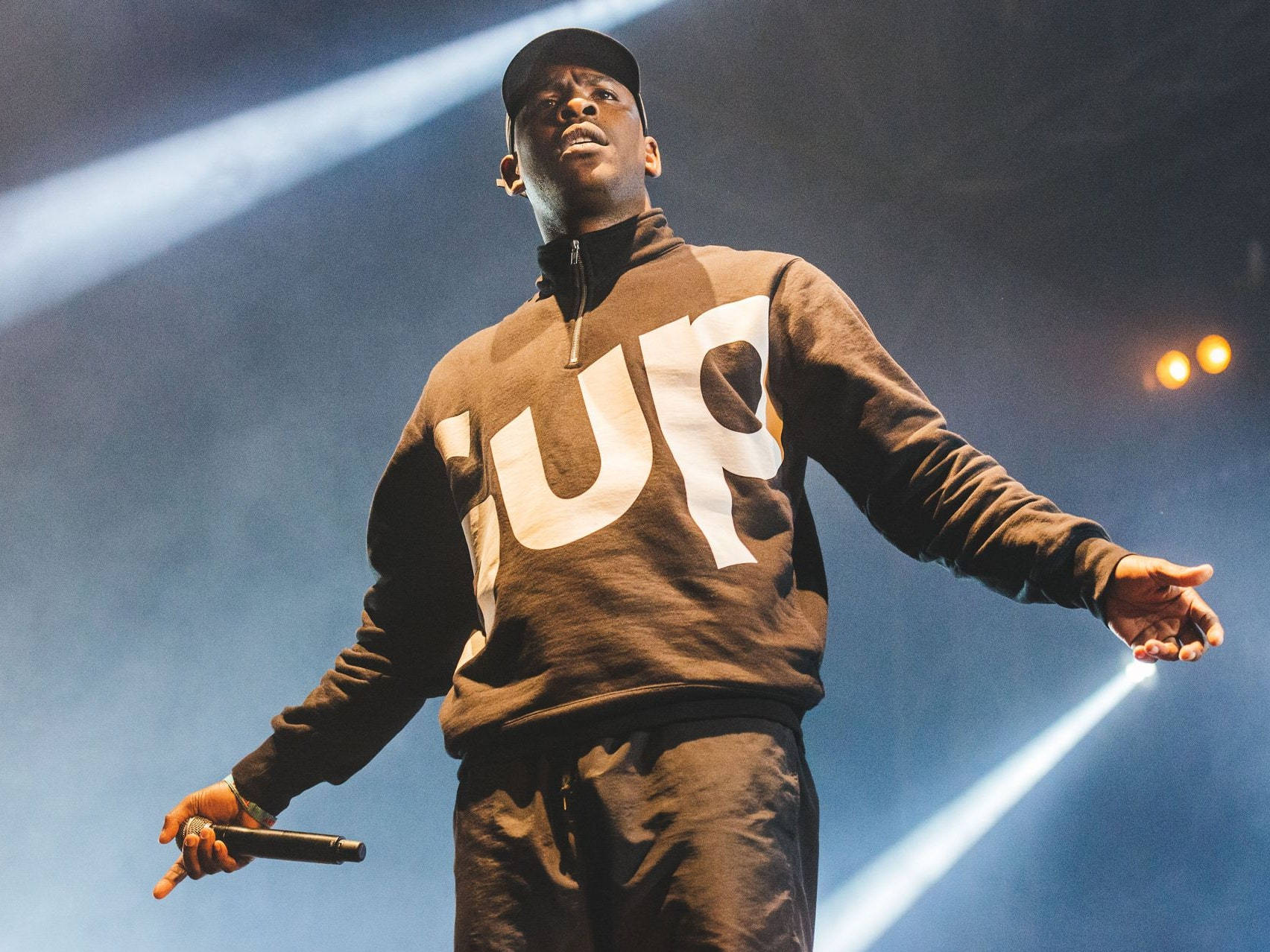 Skepta, brown 'SUP' hoodie, bright blue spotlights, HD Desktop Wallpaper