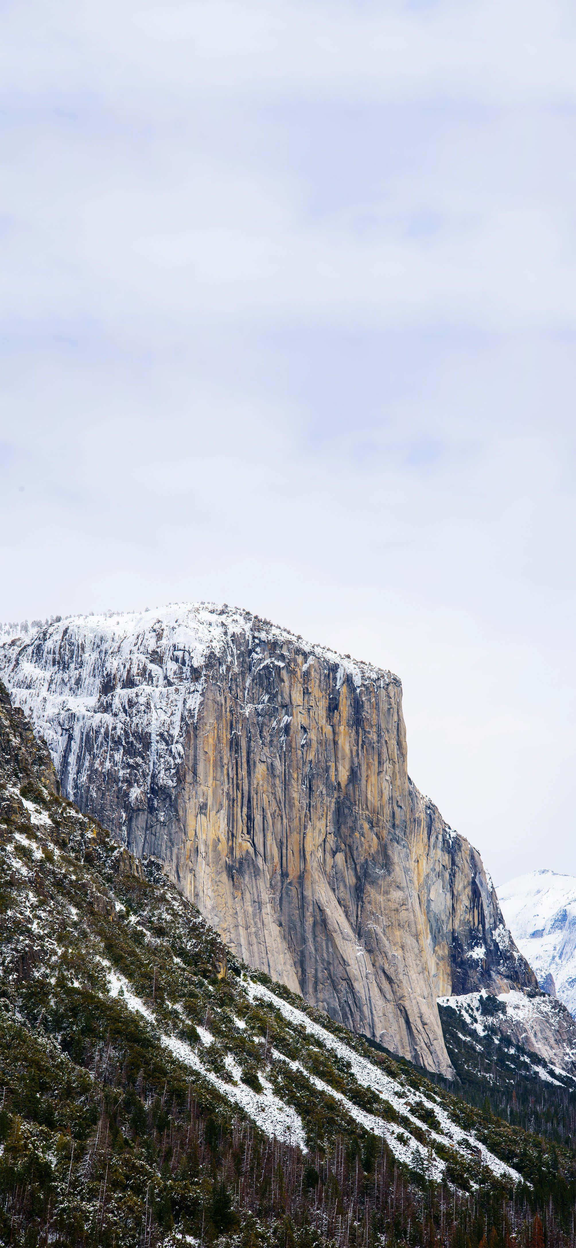 el capitan, snow-dusted granite cliff, pale sky, 4K Phone Wallpaper