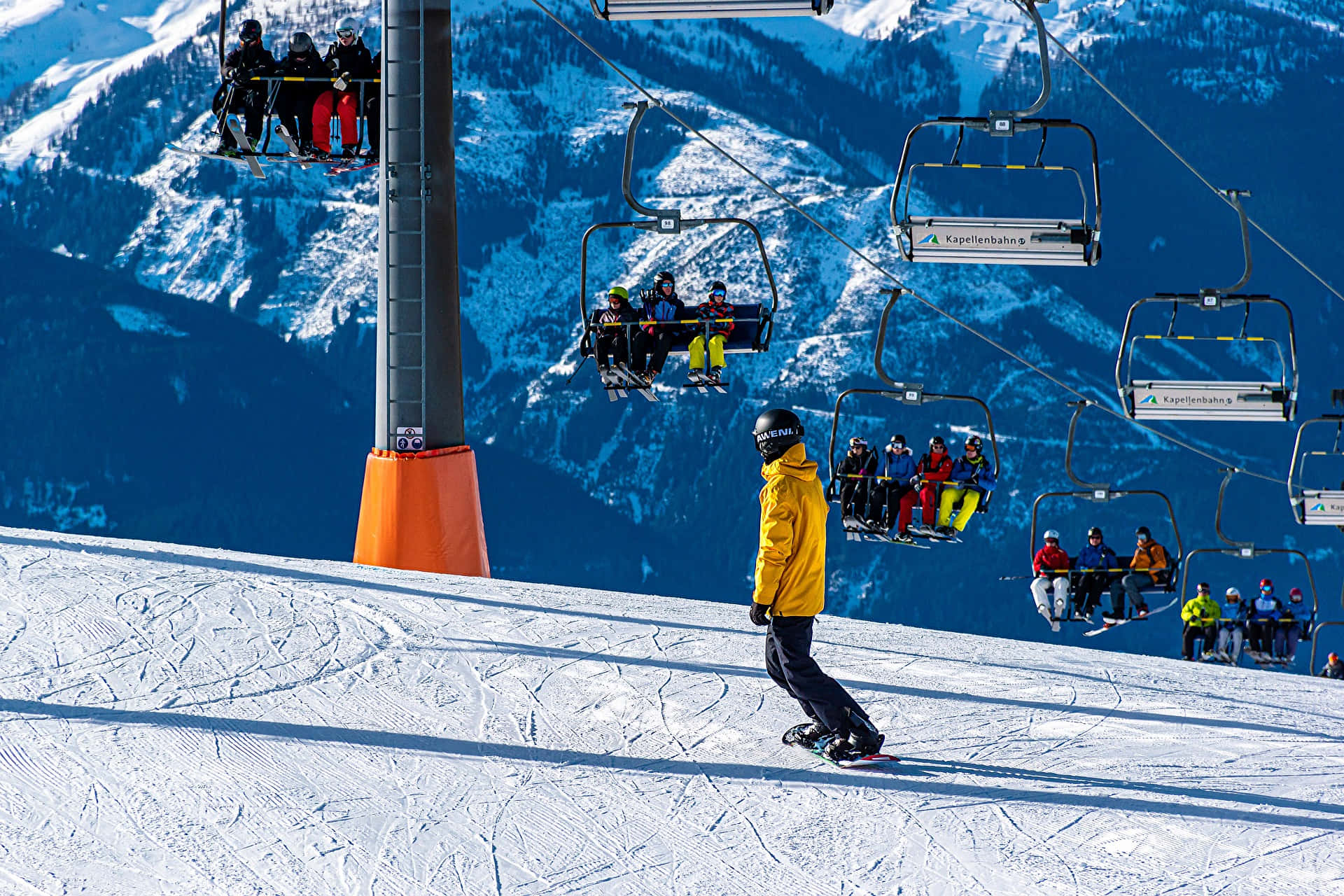 snowboarder, bright yellow jacket, sunlit slope, Full HD Desktop Wallpaper