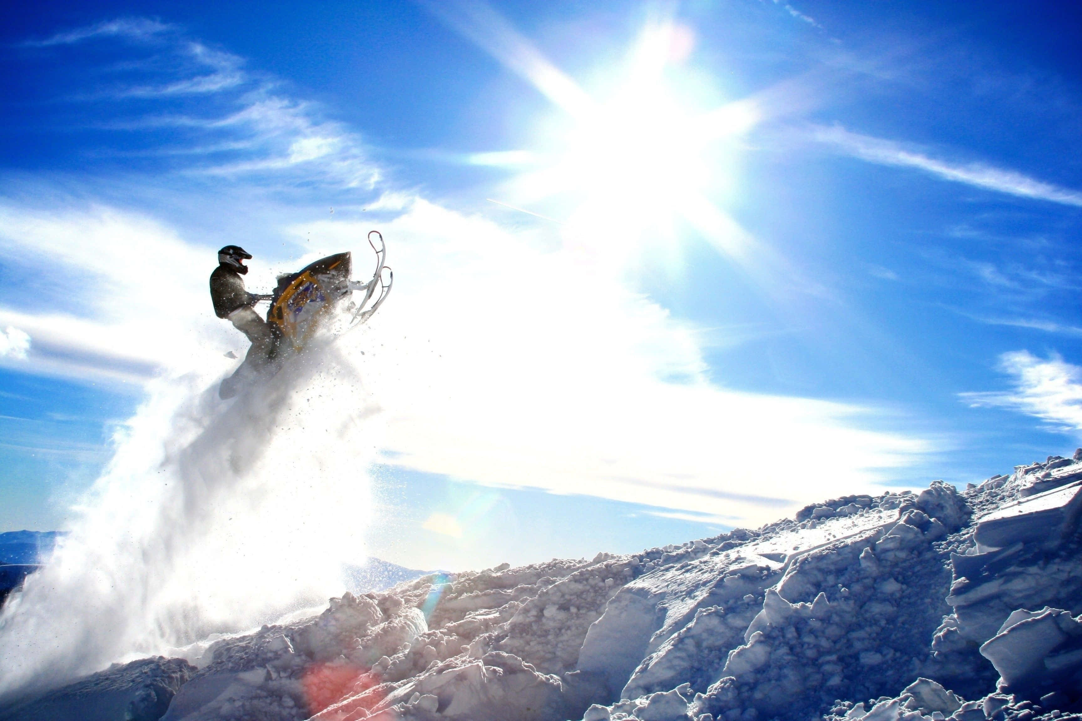 snowmobile rider, snowy mountain ridge, blazing sun, 2K Desktop Wallpaper
