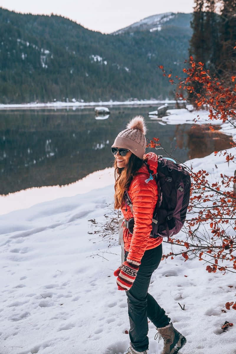 bright orange jacket, pink beanie, snowy woods, SD Phone Wallpaper