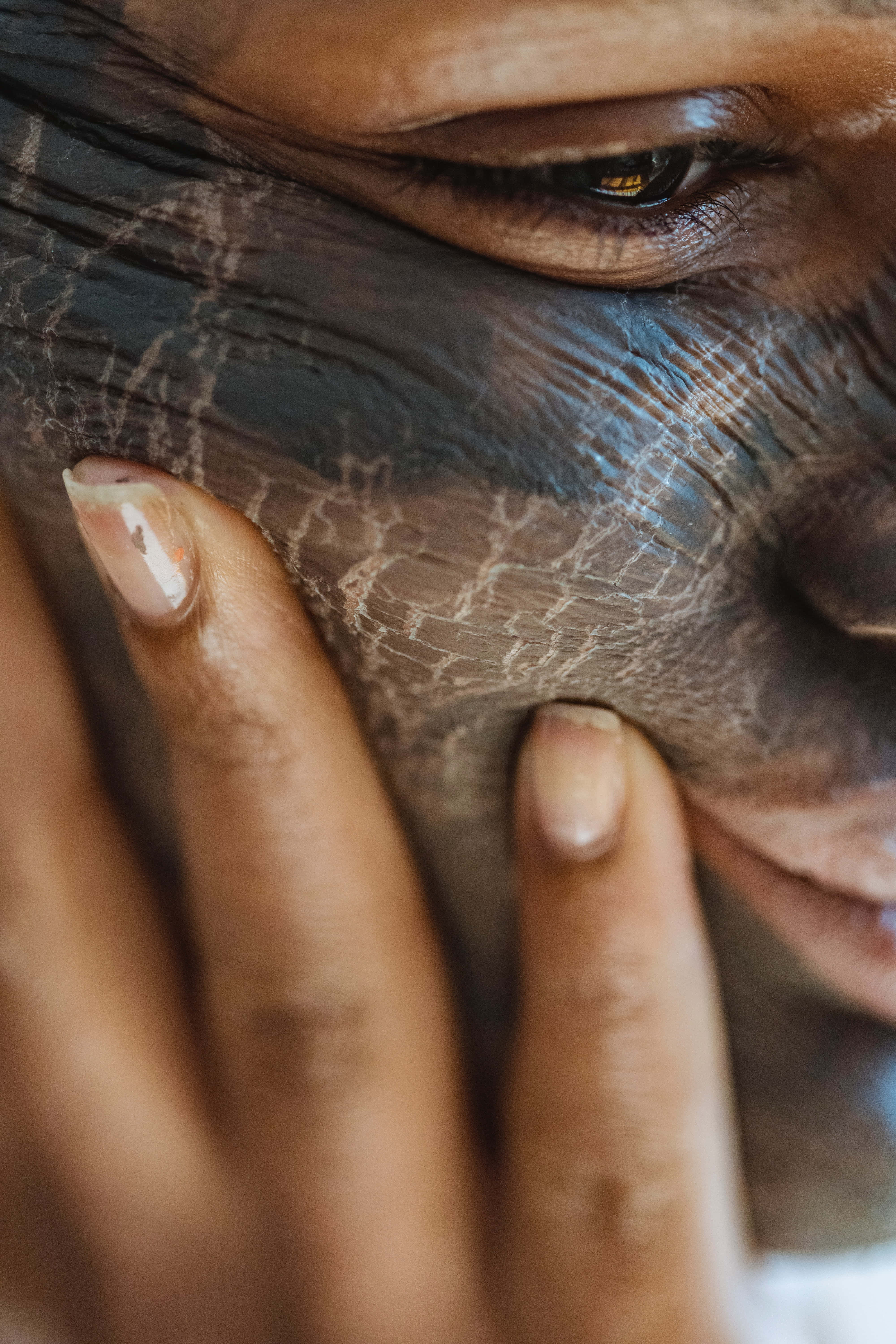 permanent wrinkle removal mask, textured reptilian skin, hand gently touching cheek, 5K Phone Wallpaper