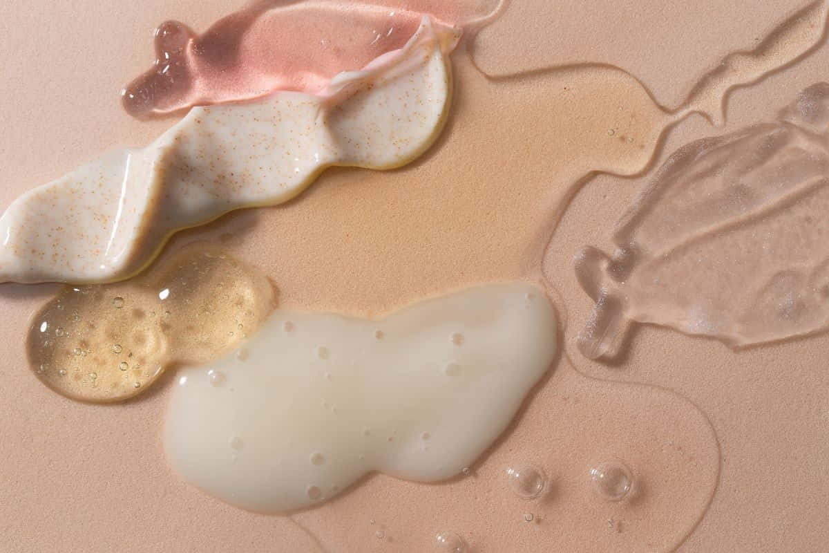 pastel beauty products, creamy textures, soft peach surface, SD Desktop Wallpaper