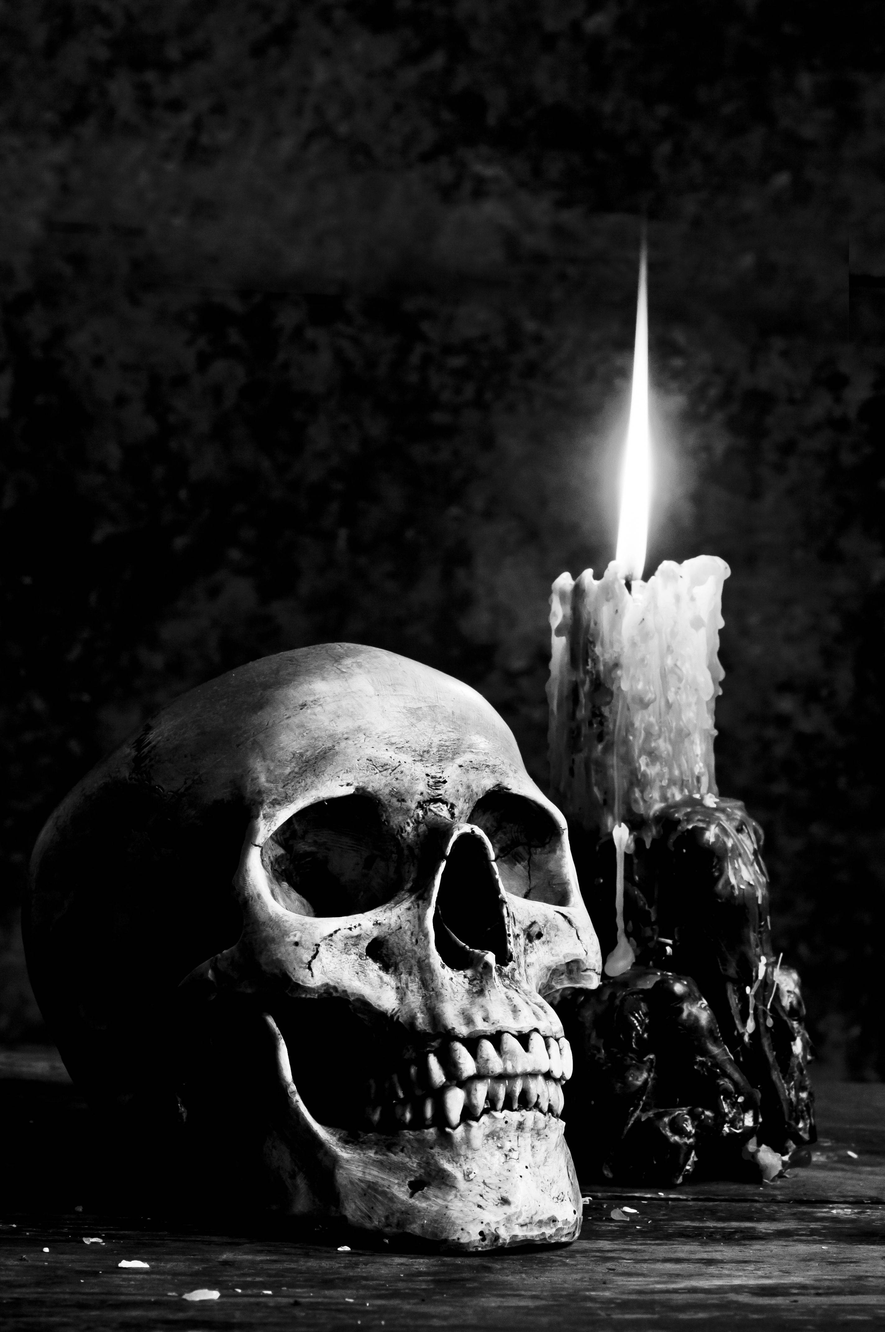 human skull, melting candle, bright flame, 4K Phone Wallpaper
