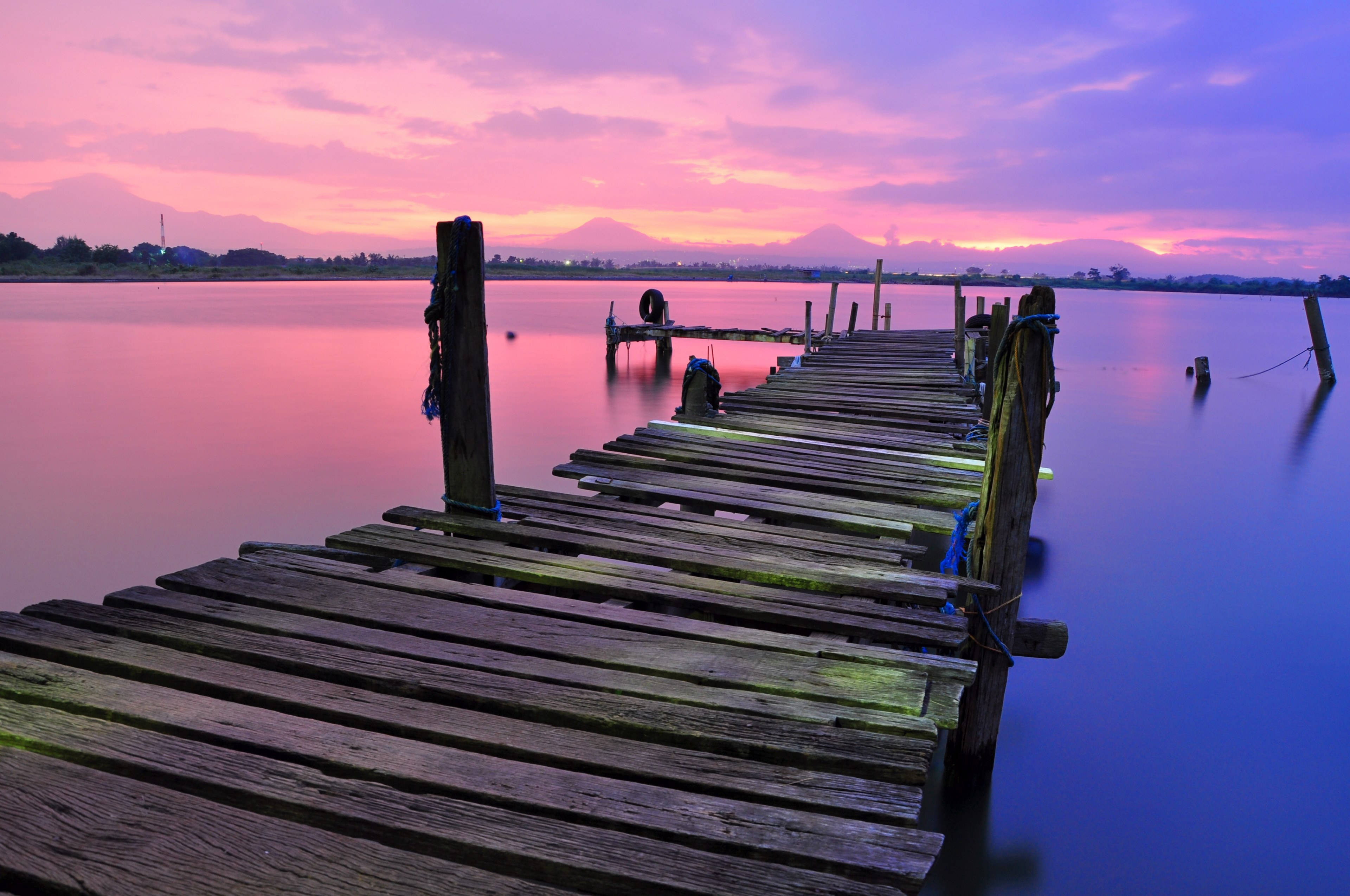 abandoned wooden lake dock, calm lake, vibrant pink and purple sunset sky, 4K Desktop Wallpaper
