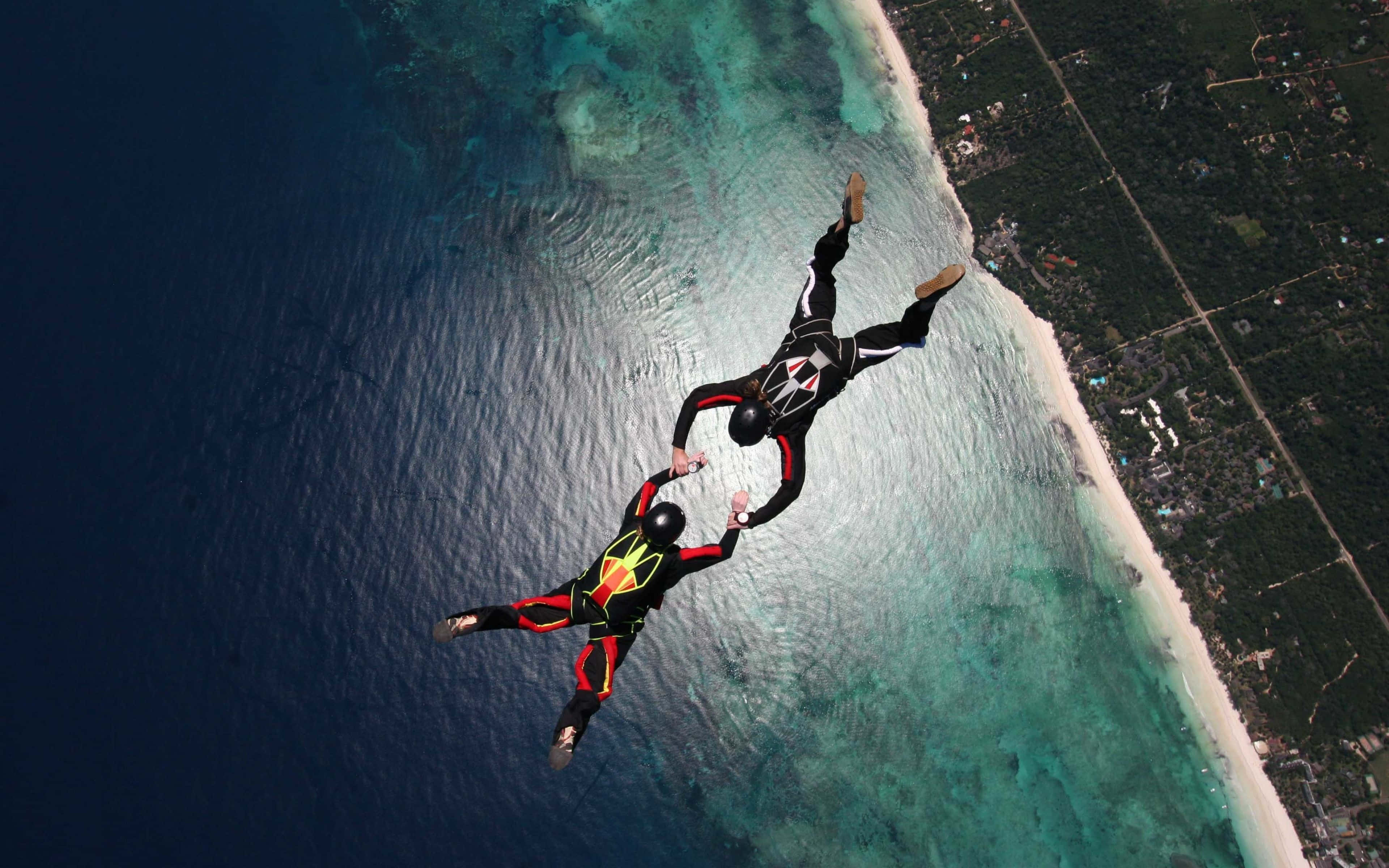 black red and yellow suits, turquoise ocean, white sandy beach, 4K Desktop Wallpaper