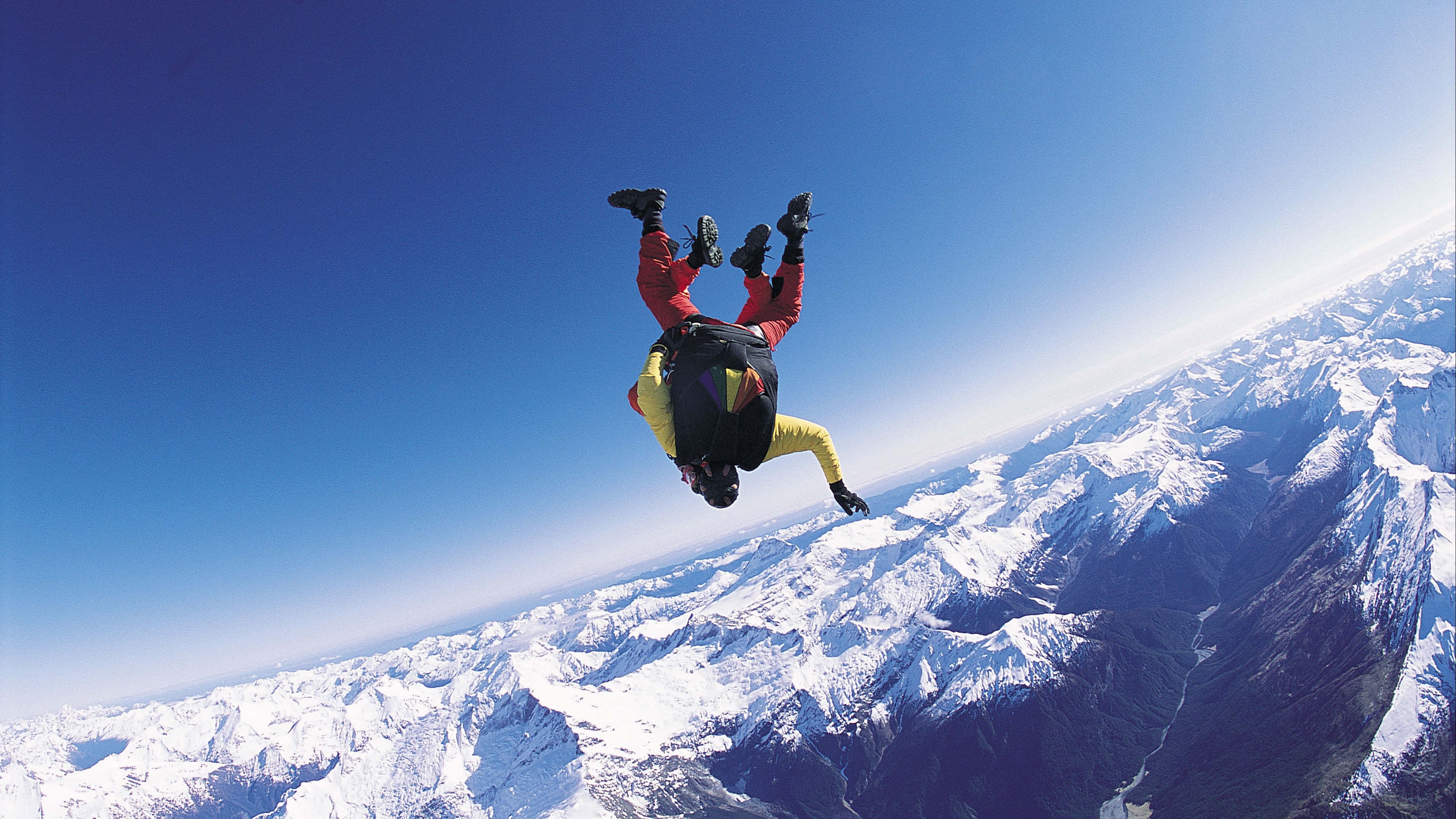 tandem skydiving, red and yellow gear, vast blue sky, 4K Desktop Wallpaper