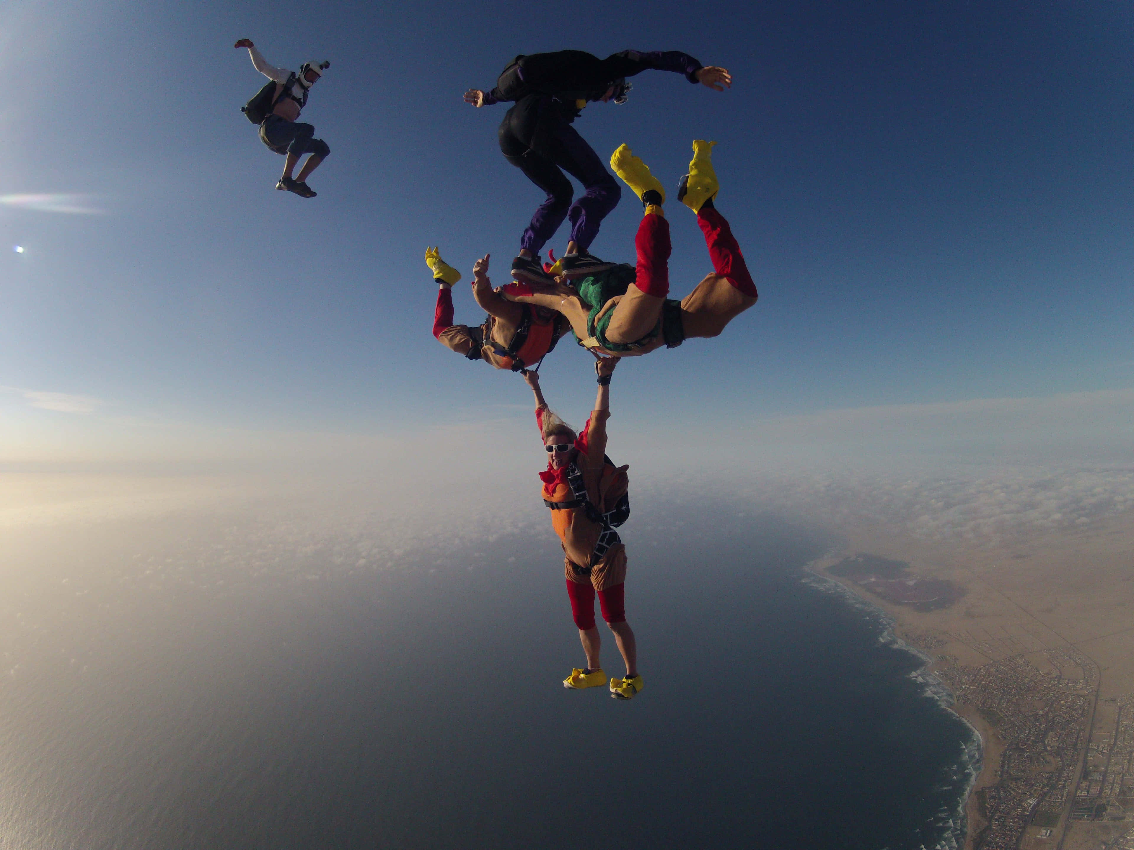 skydiving formation, coastal city, ocean, 4K Desktop Wallpaper