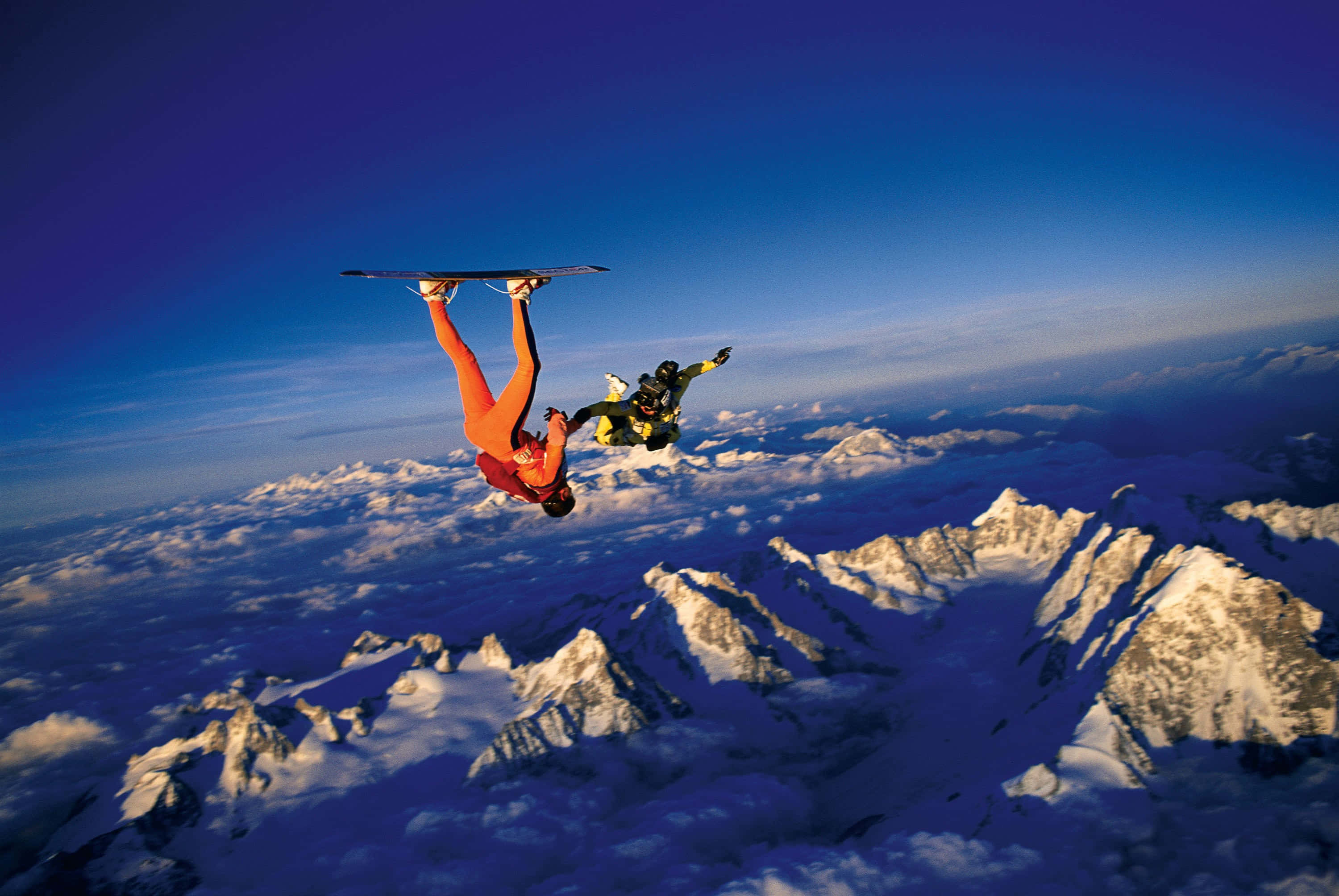 skydiving, snowcapped mountains, vibrant suits, 2K Desktop Wallpaper