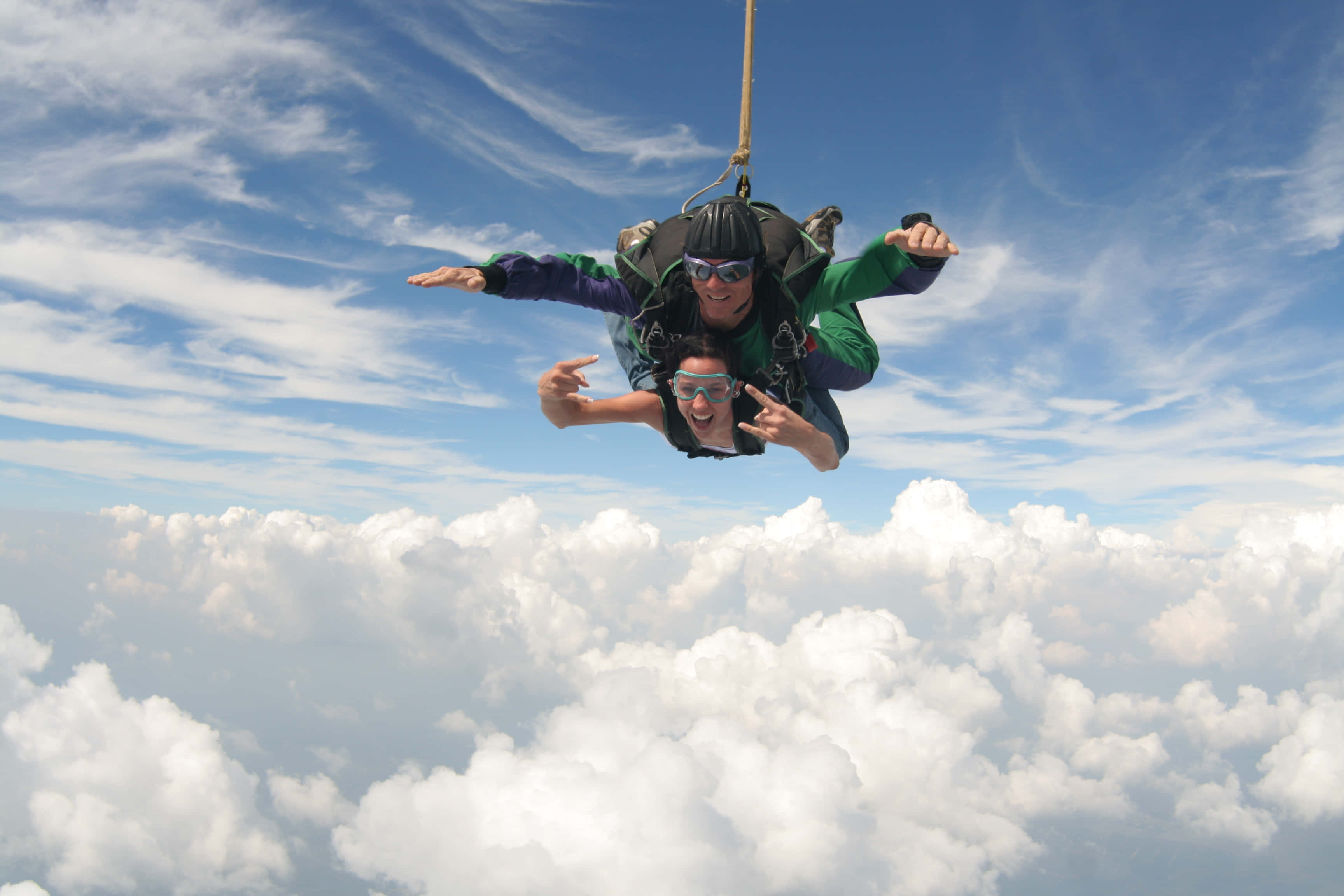 tandem skydiving, bright blue sky, fluffy white clouds, 2K Desktop Wallpaper