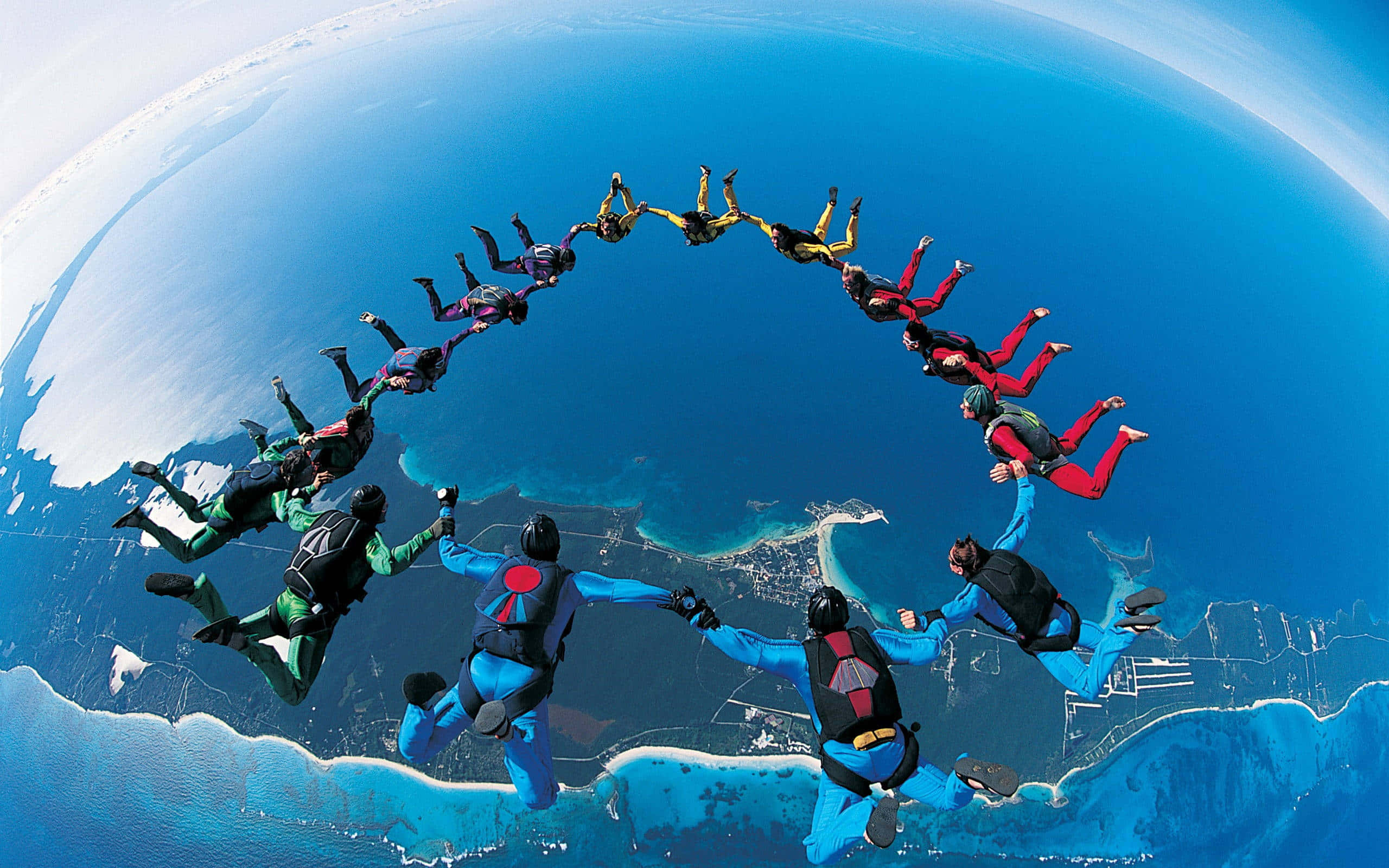 large circle formation, colorful suits, mid-air, 2K Desktop Wallpaper