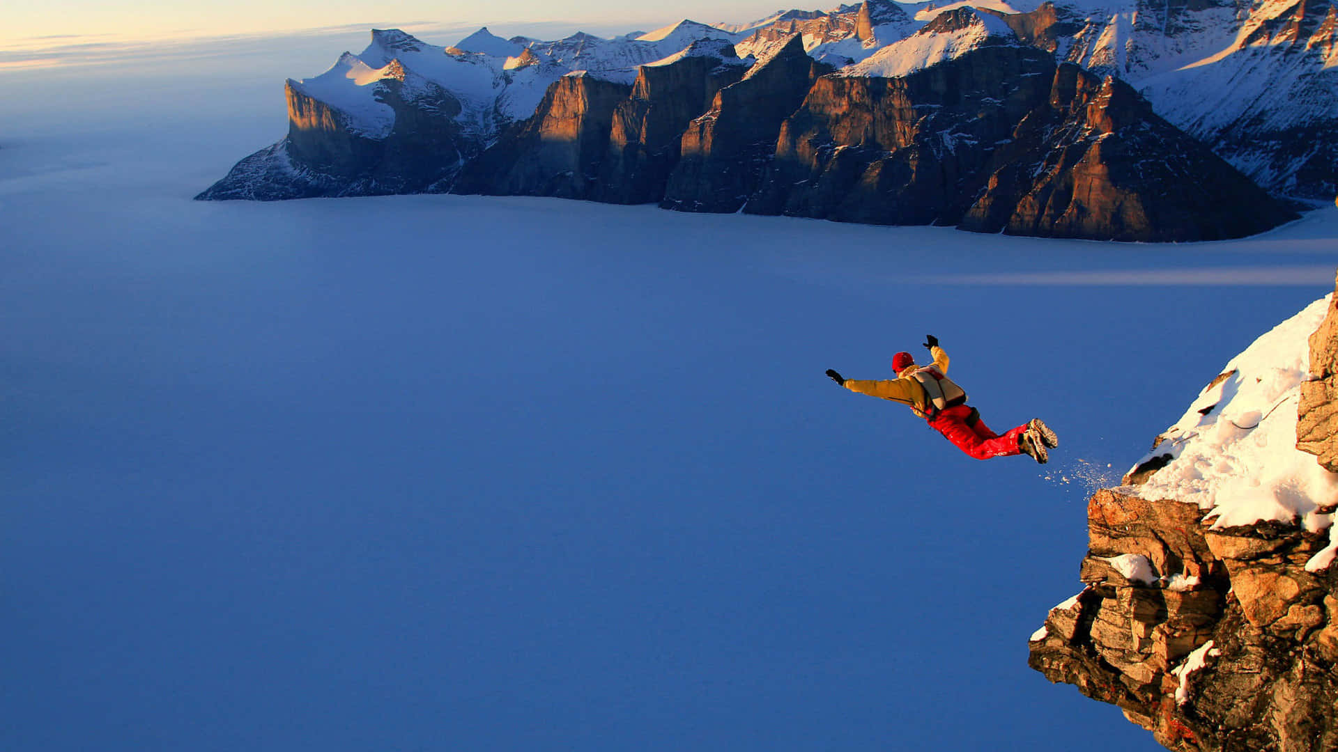 red jumpsuit, snowy cliff, vast blue frozen sea, Full HD Desktop Wallpaper