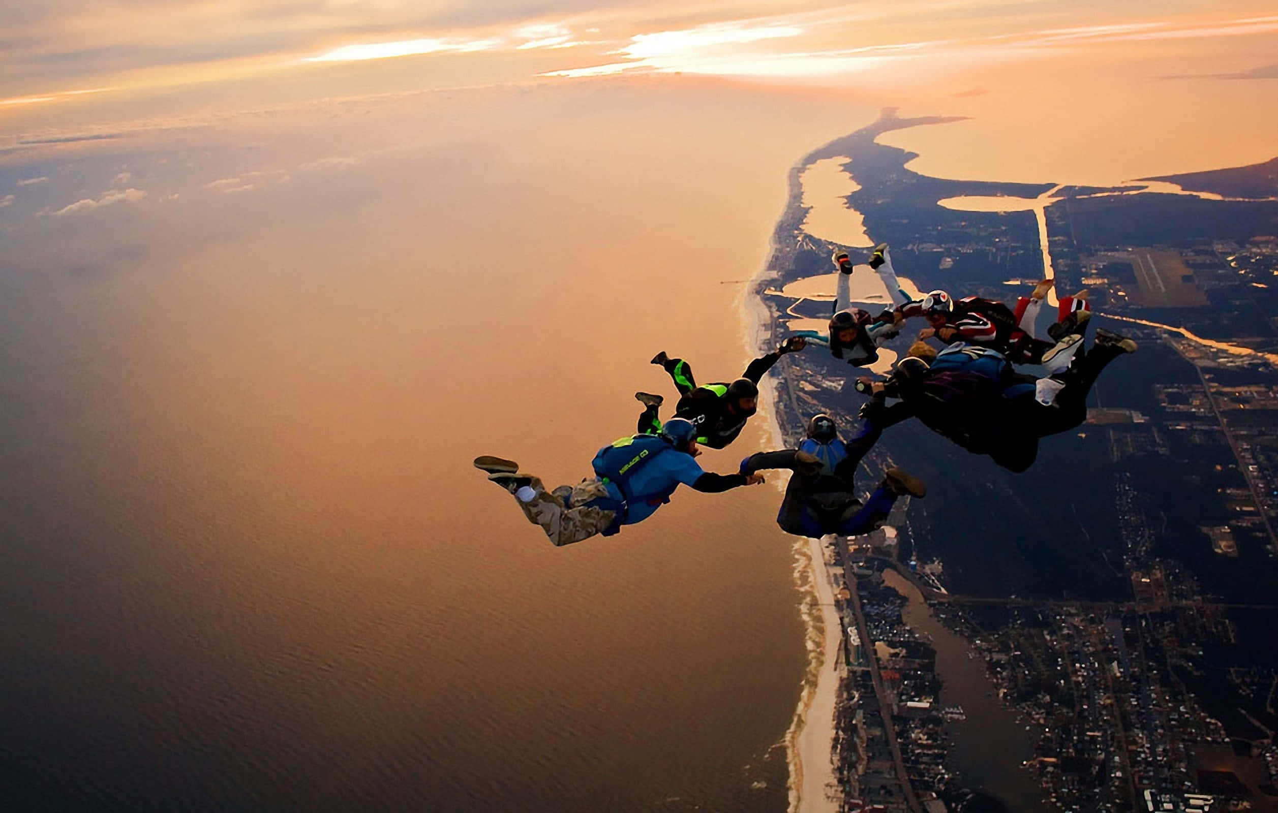 skydiving formation, coastal city, golden sunset, Full HD Desktop Wallpaper