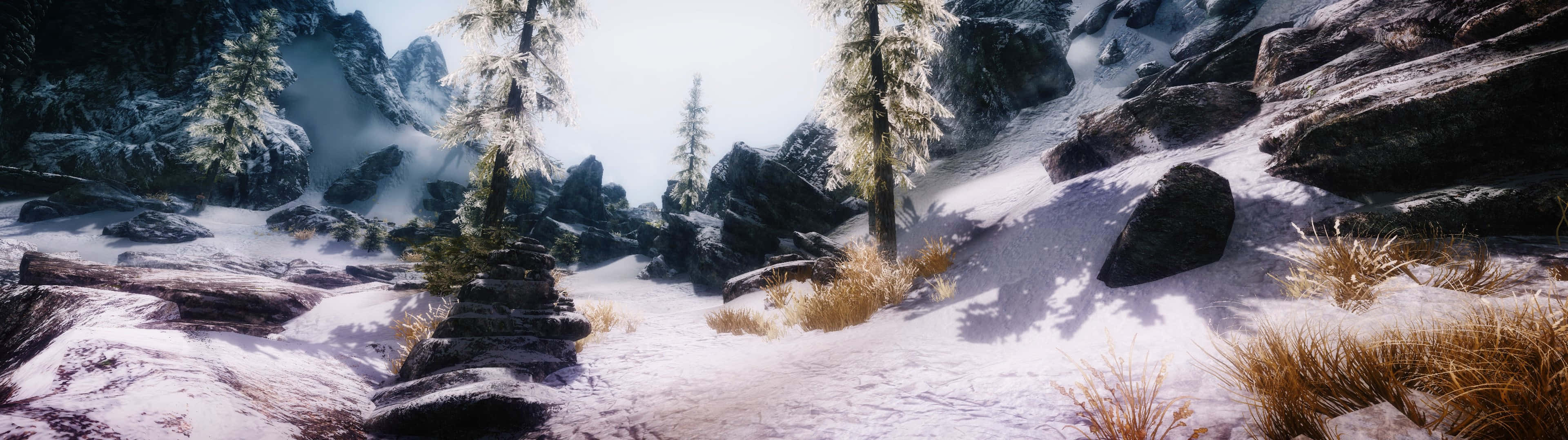 Skyrim, rugged mountains, frost-covered pines, 4K Desktop Wallpaper