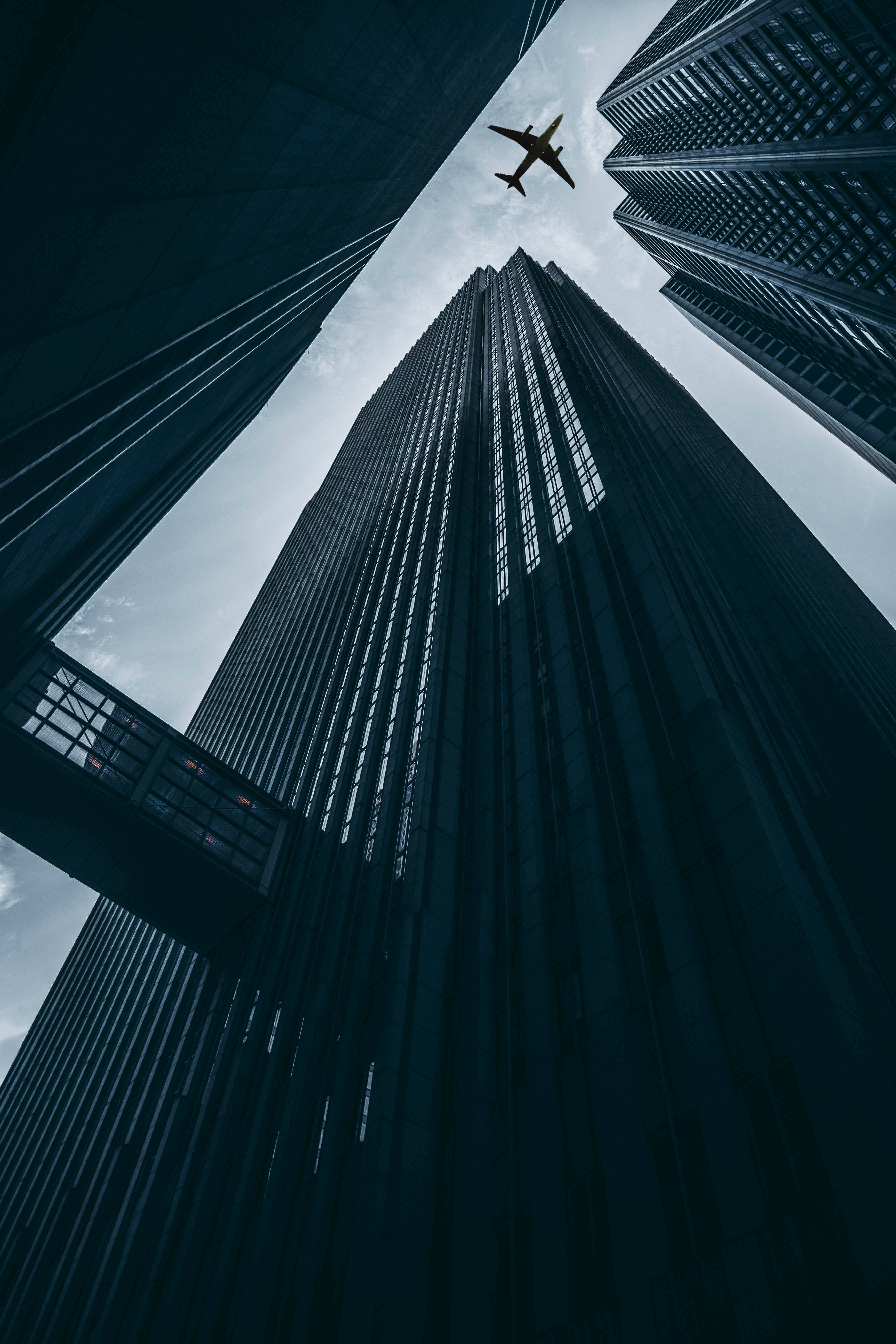 airplane, towering skyscrapers, cloudy sky, 5K Phone Wallpaper