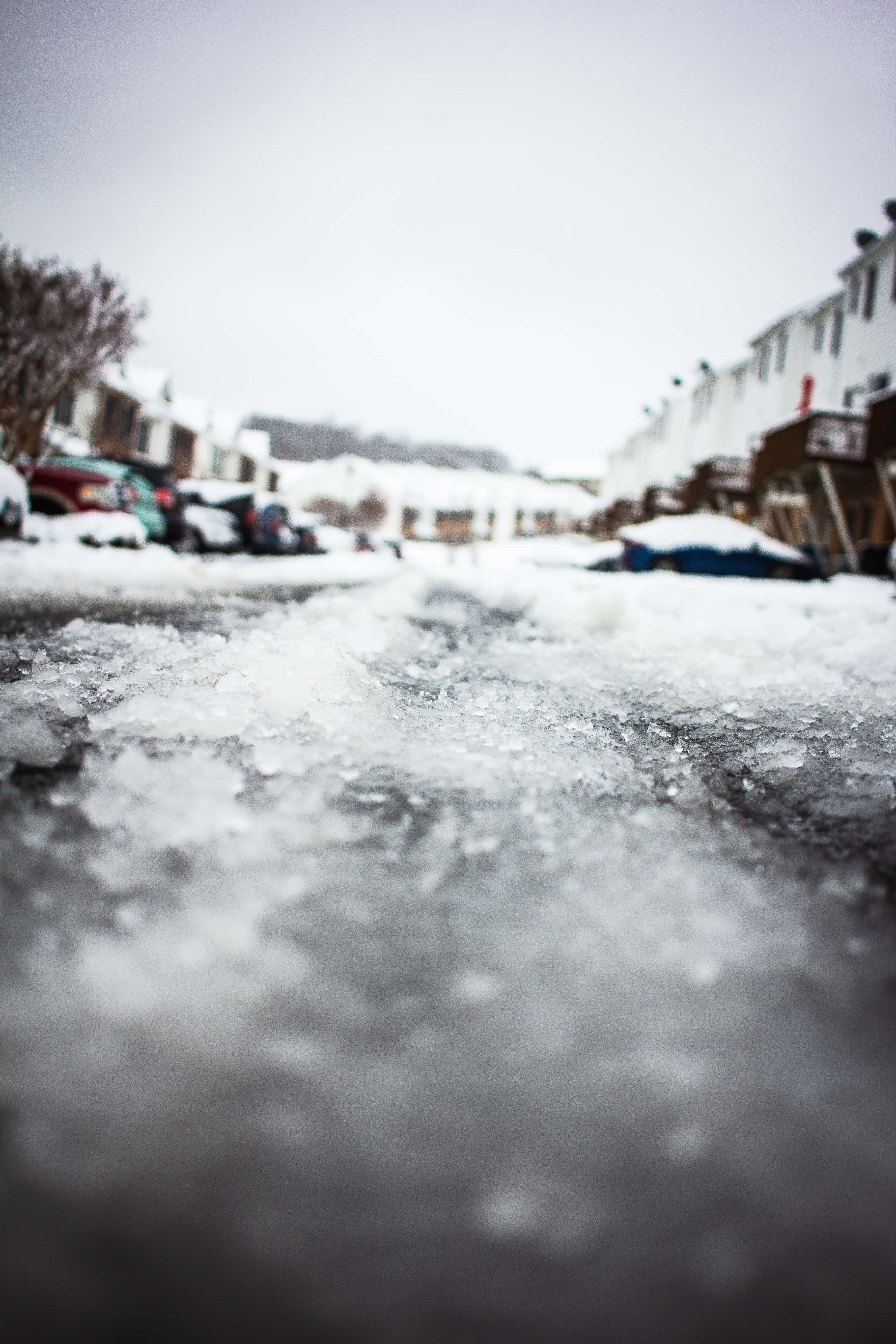 Sleet, icy pavement, snow-dusted residential street, 5K Phone Wallpaper