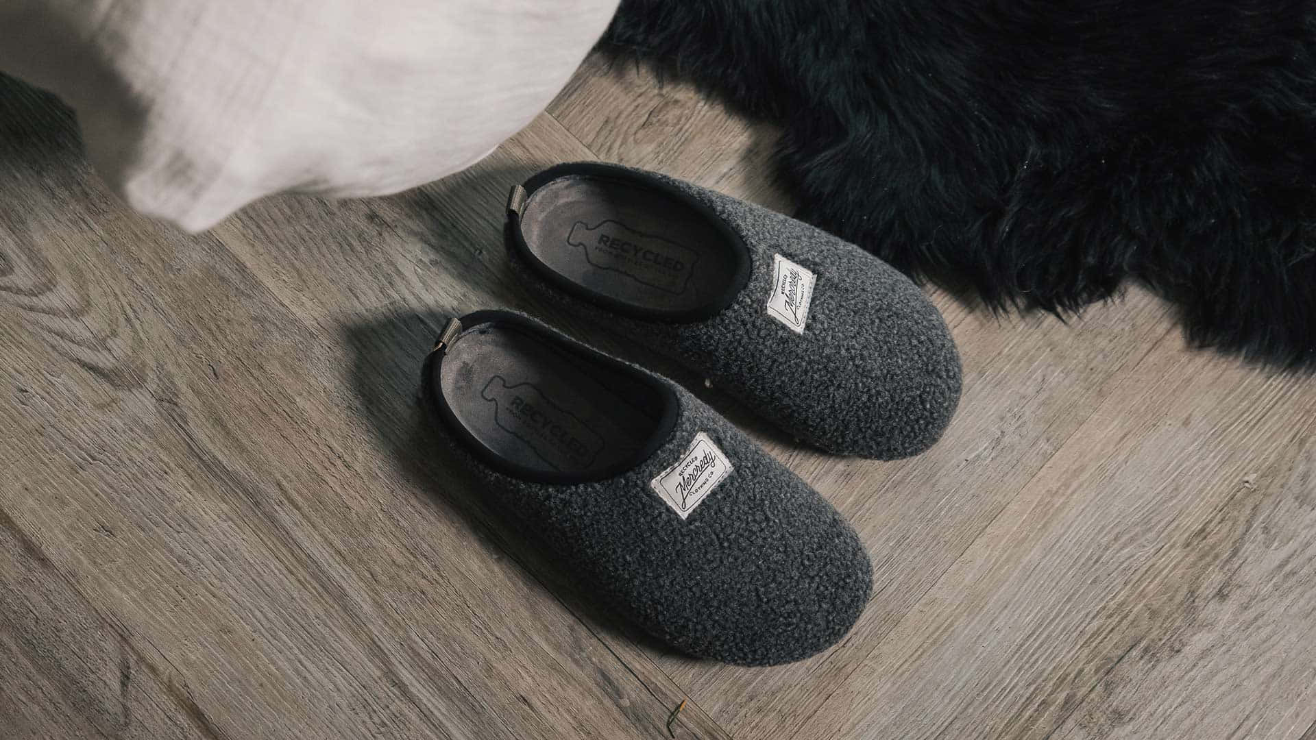 Cozy Home Slipperson, dark gray fuzzy slippers, light wood flooring, Full HD Desktop Wallpaper