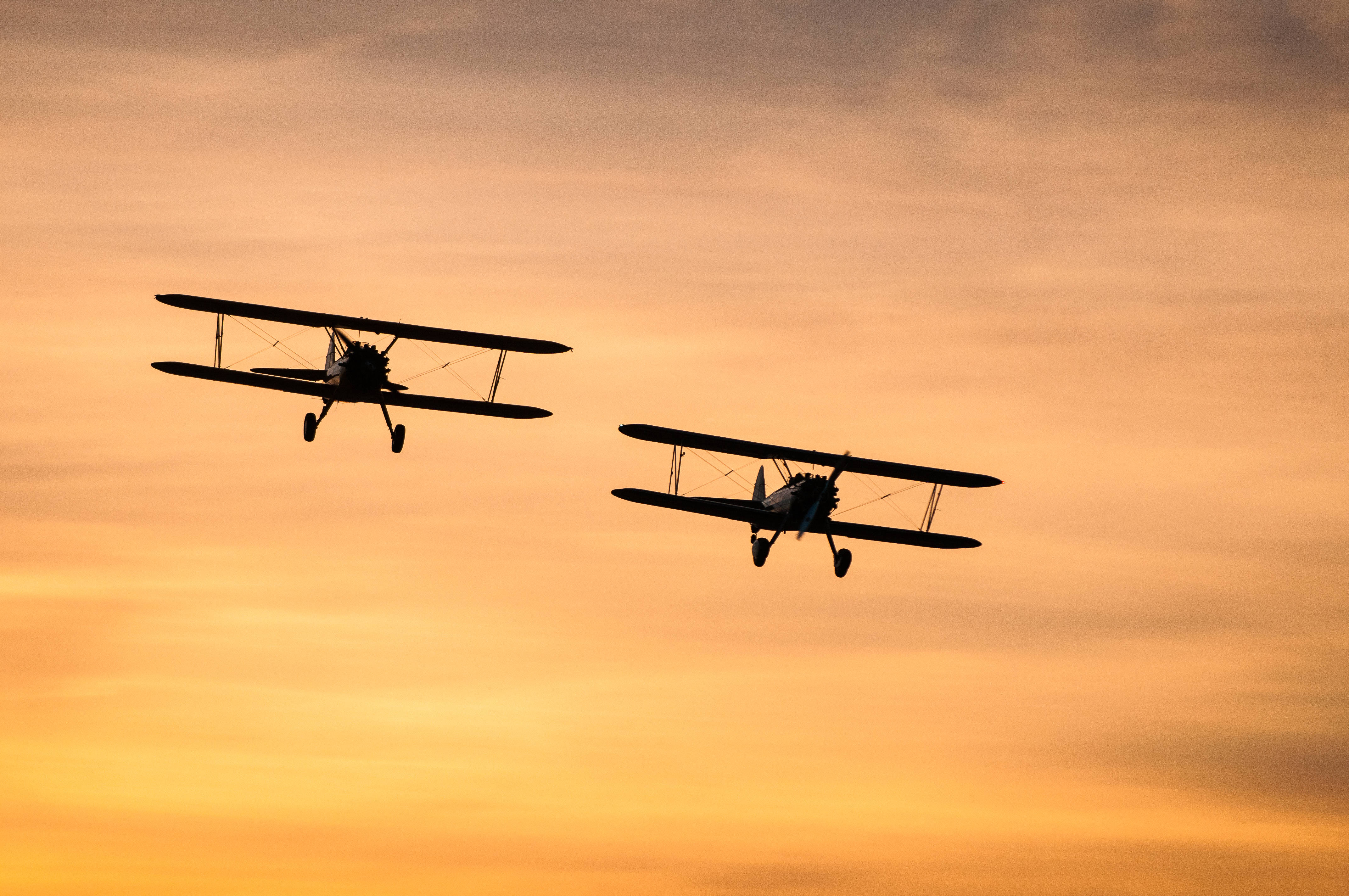 vintage biplanes, fiery orange and yellow sunset sky, silhouette, 4K Desktop Wallpaper
