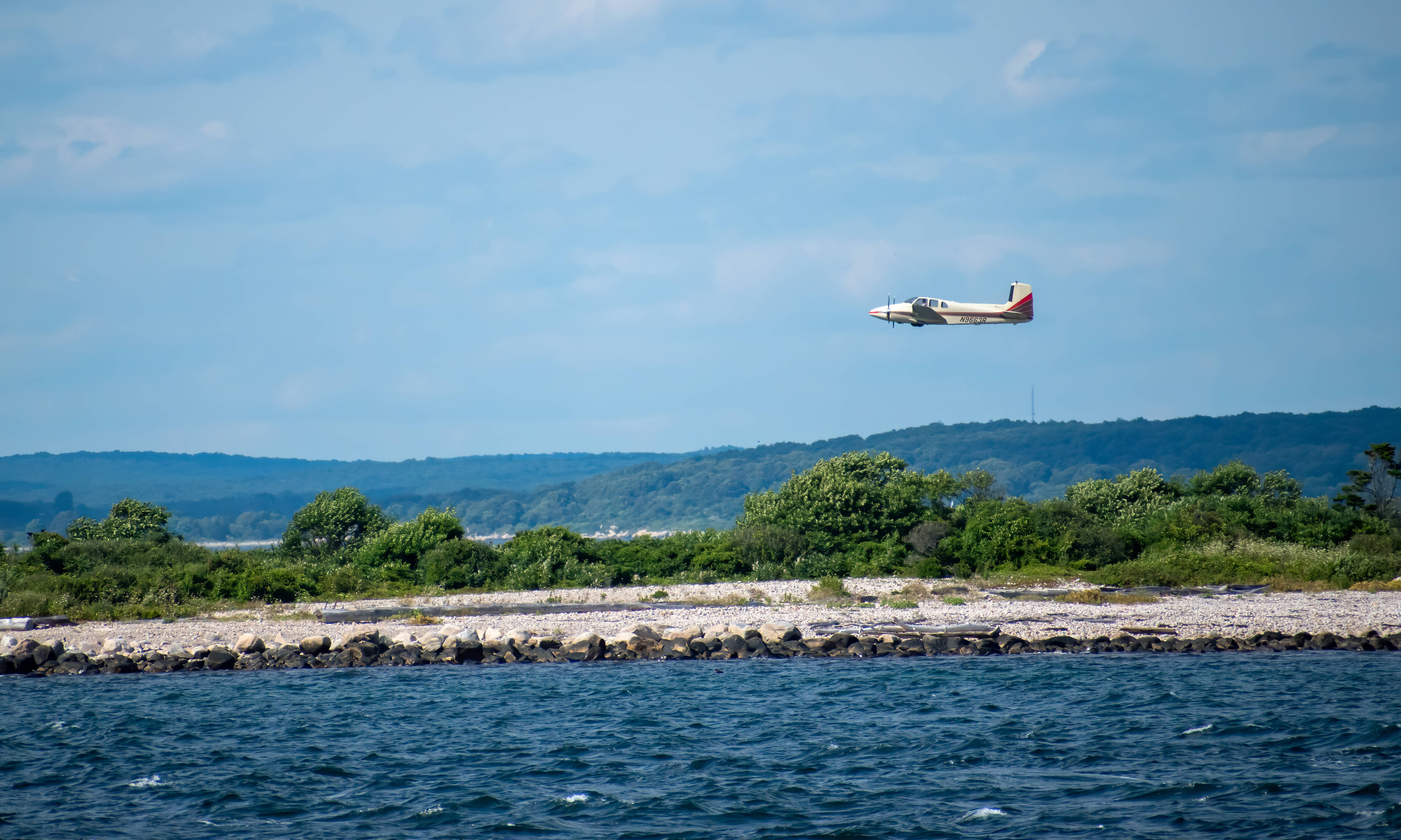 small seaplane, calm blue water, rocky shoreline, 4K Desktop Wallpaper