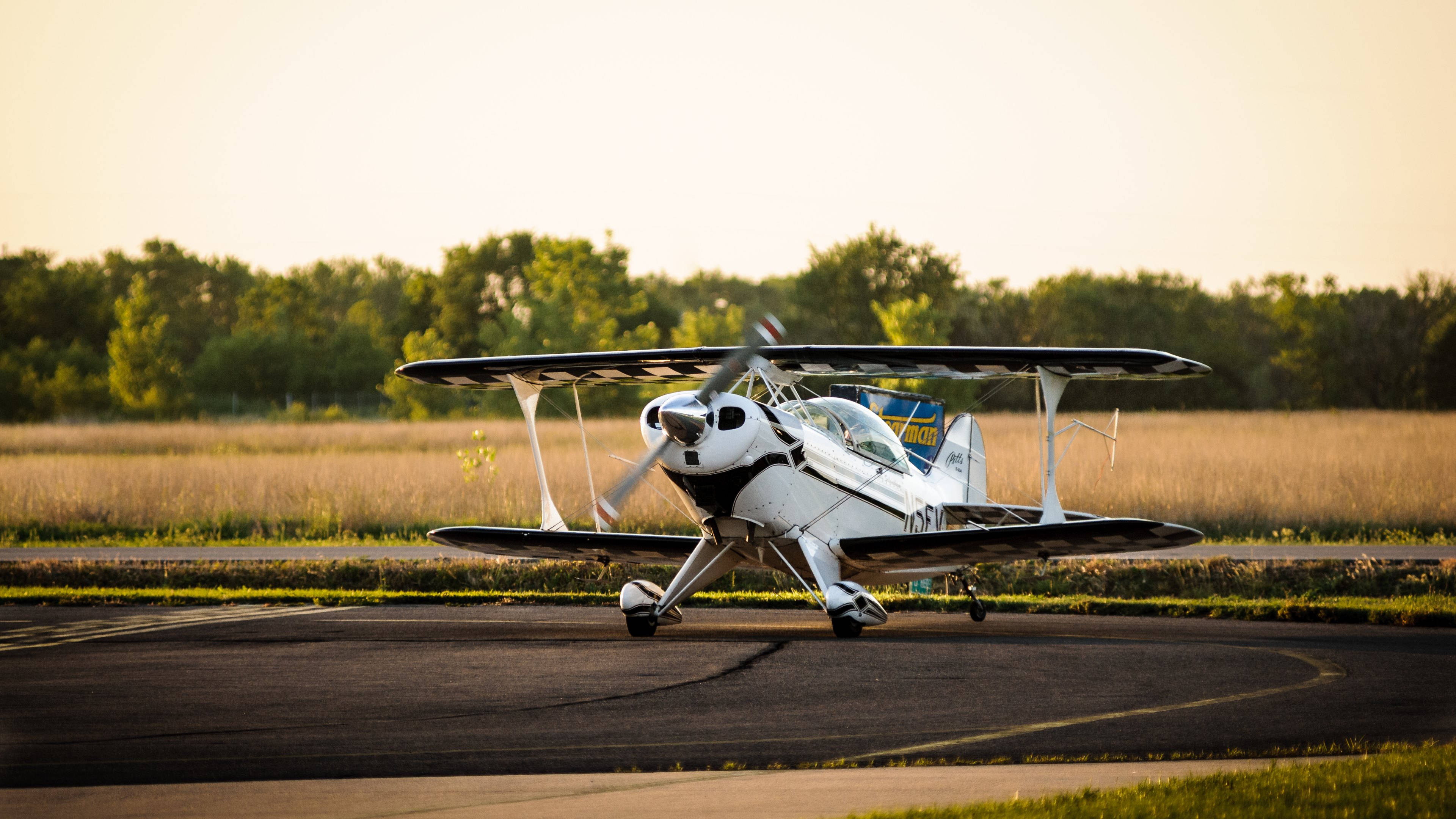 white biplane, black accents, runway, 4K Desktop Wallpaper