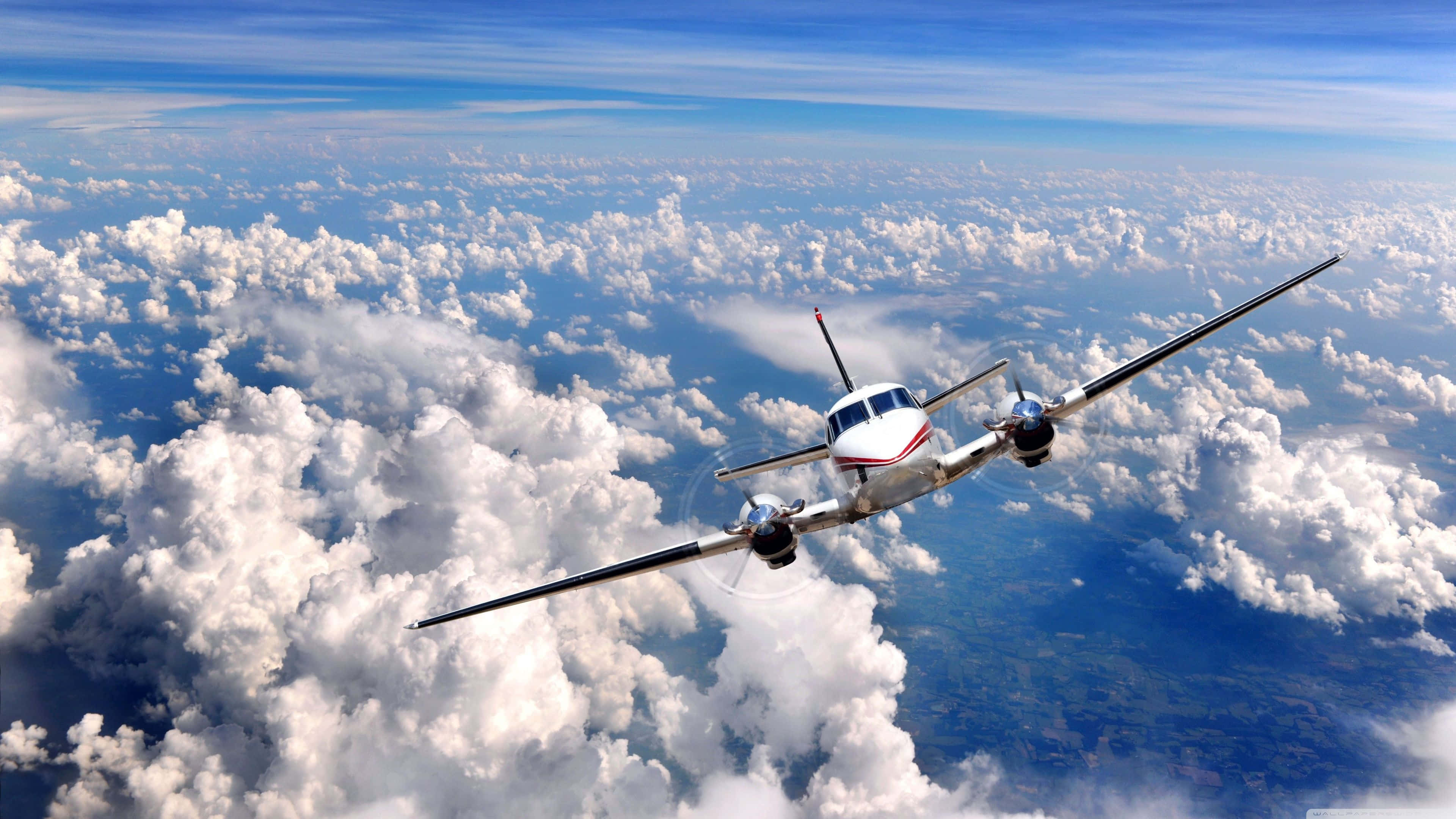 white twin-engine propeller plane, fluffy white clouds, blue sky, 4K Desktop Wallpaper