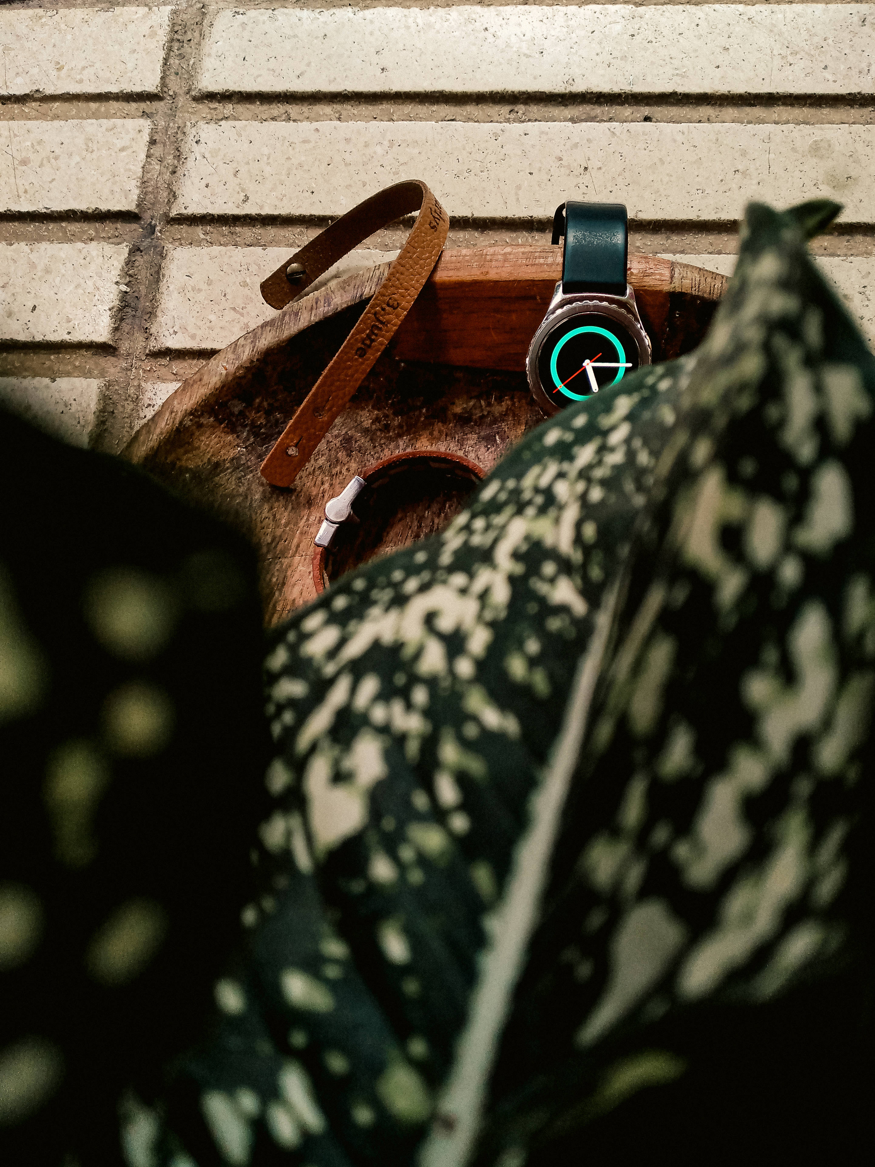 smartwatch, glowing green face, wooden tray, 4K Phone Wallpaper