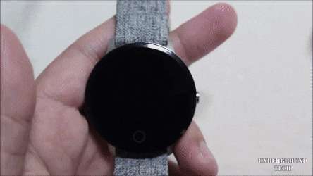 black circular smartwatch, gray fabric strap, wooden surface, SD Desktop Wallpaper