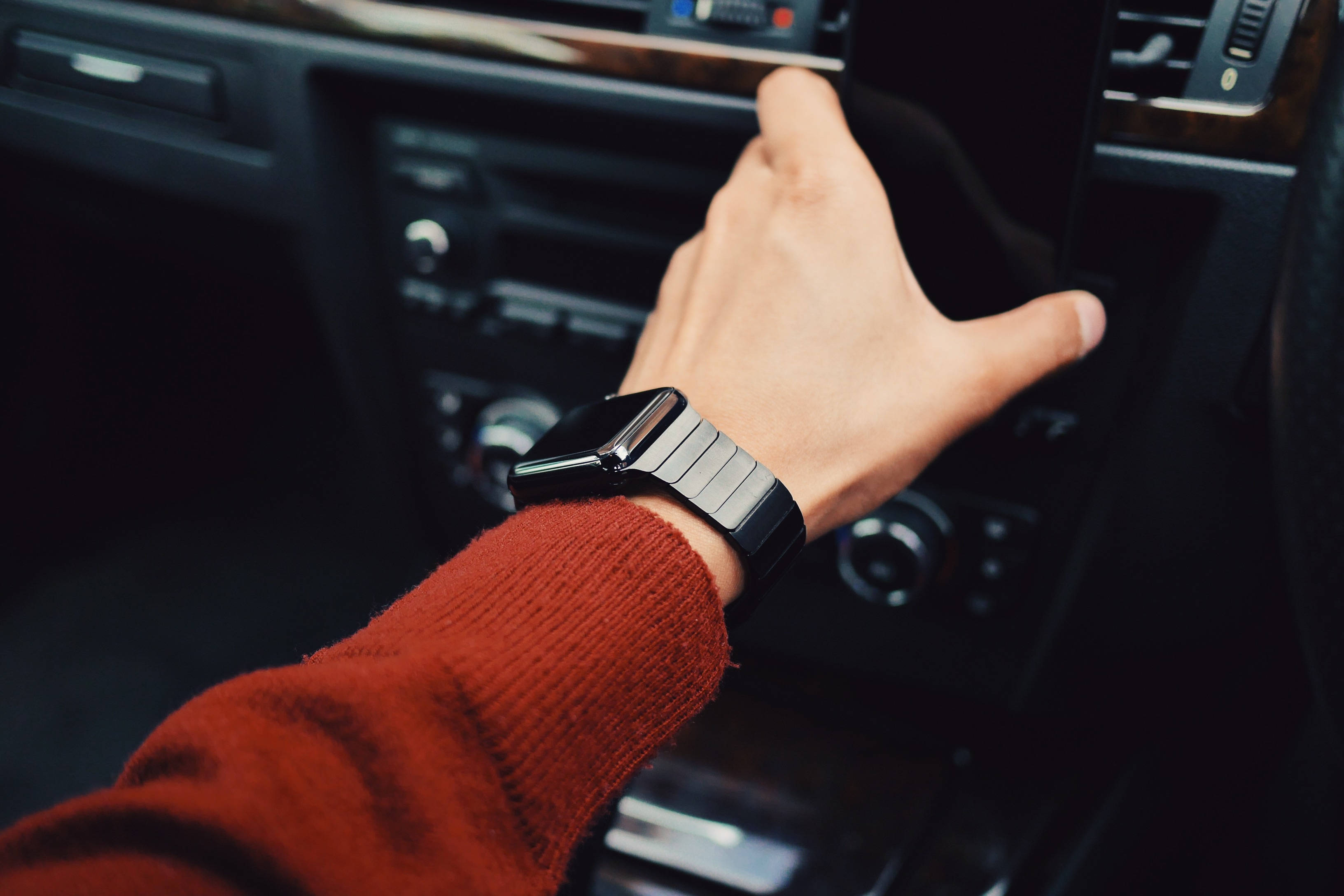 black smartwatch, red sweater, car climate controls, 2K Desktop Wallpaper