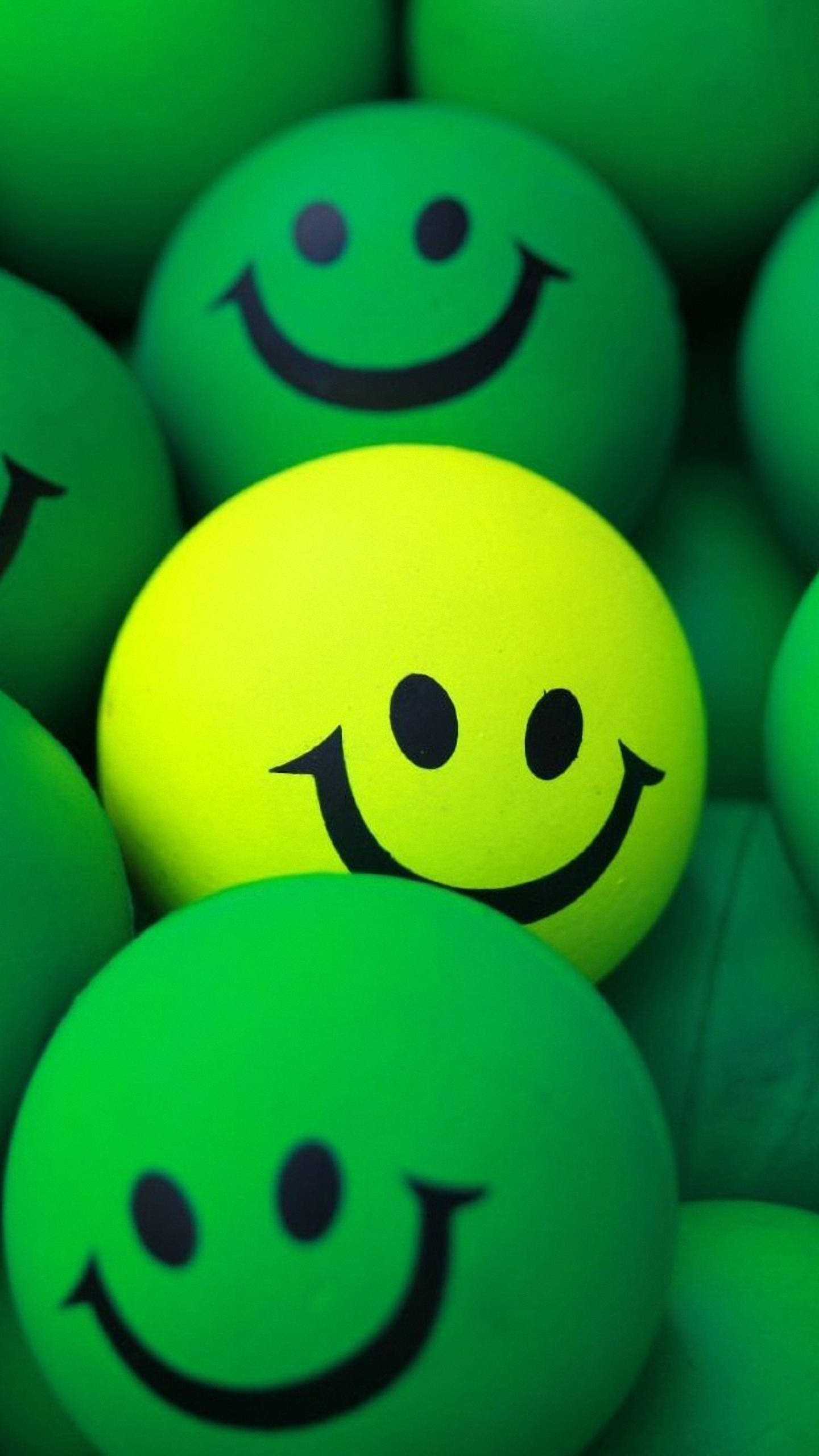 yellow smiley ball, green smiley balls, close-up shot, 2K Phone Wallpaper