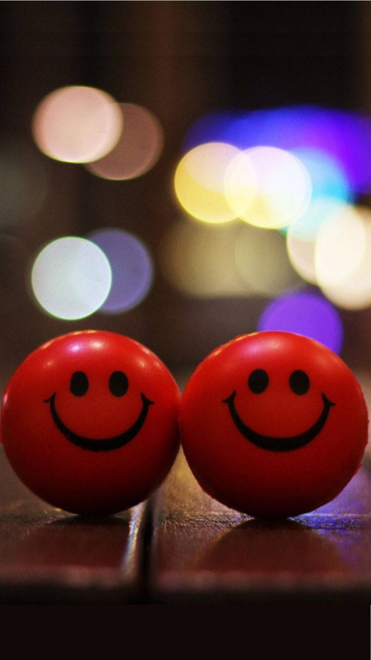 red smiley face balls, wooden surface, colorful bokeh lights, HD Phone Wallpaper
