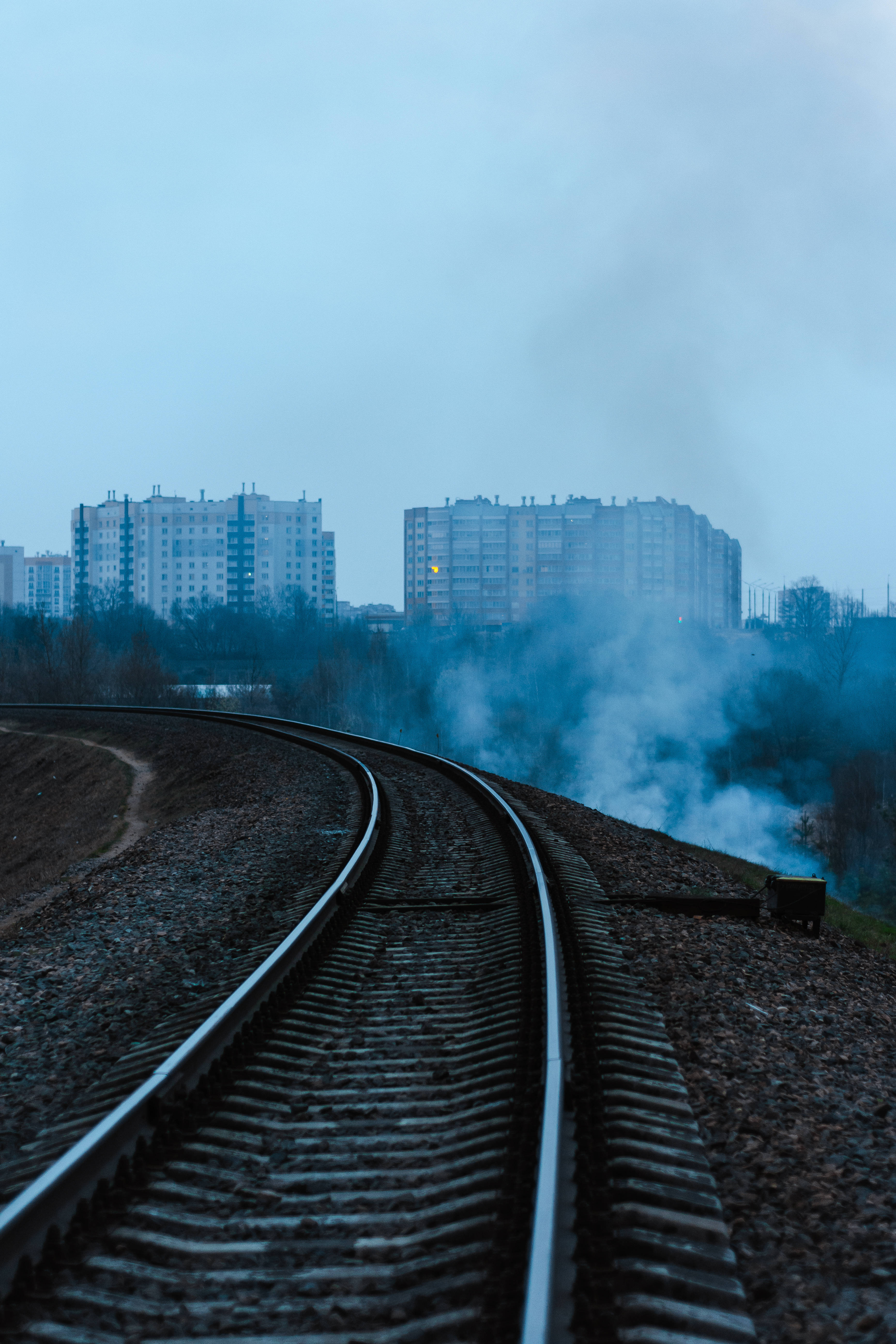 train tracks, apartment buildings, hazy blue sky, 5K Phone Wallpaper