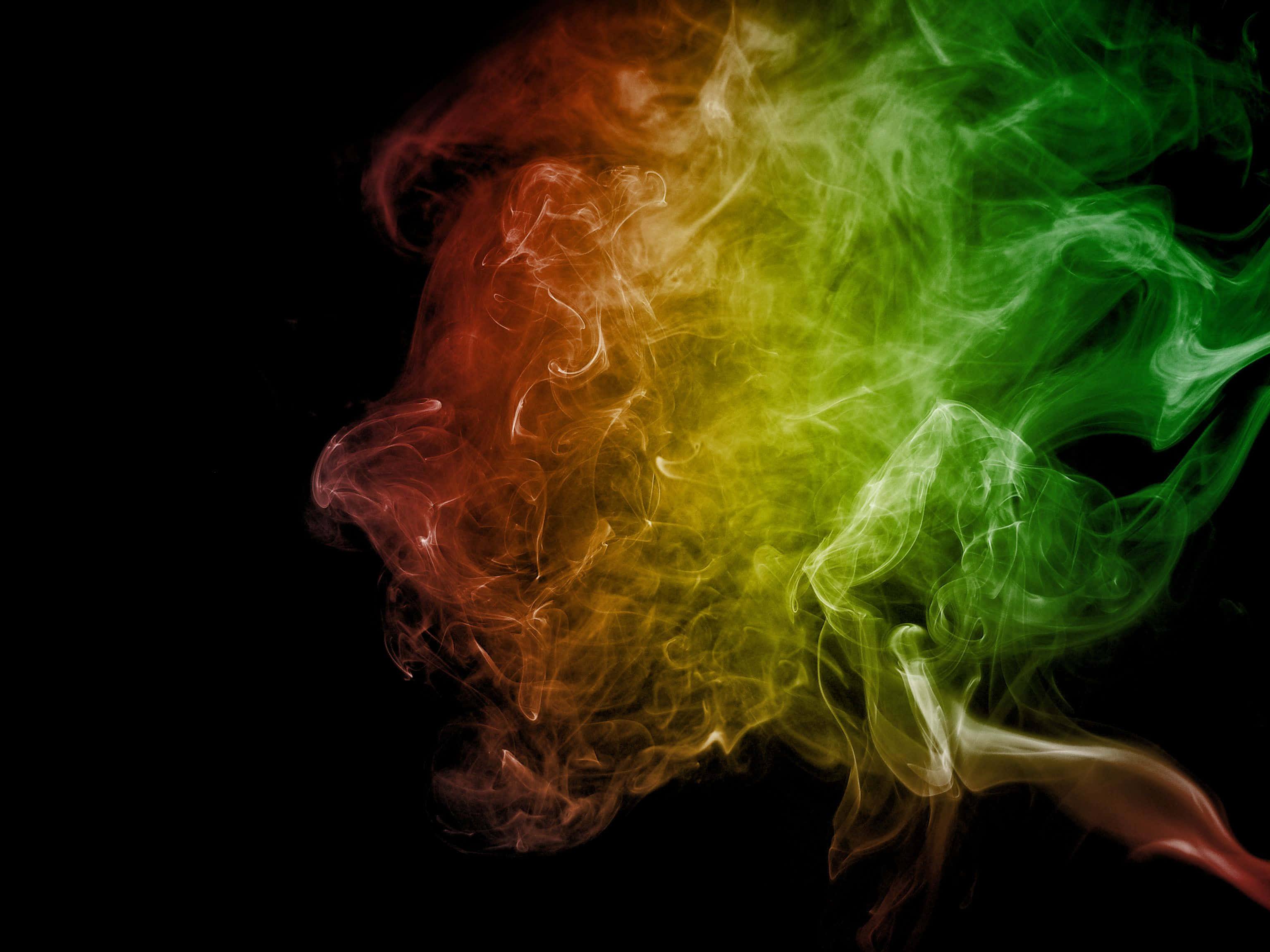 red yellow and green smoke, swirls, stark black background, 2K Desktop Wallpaper