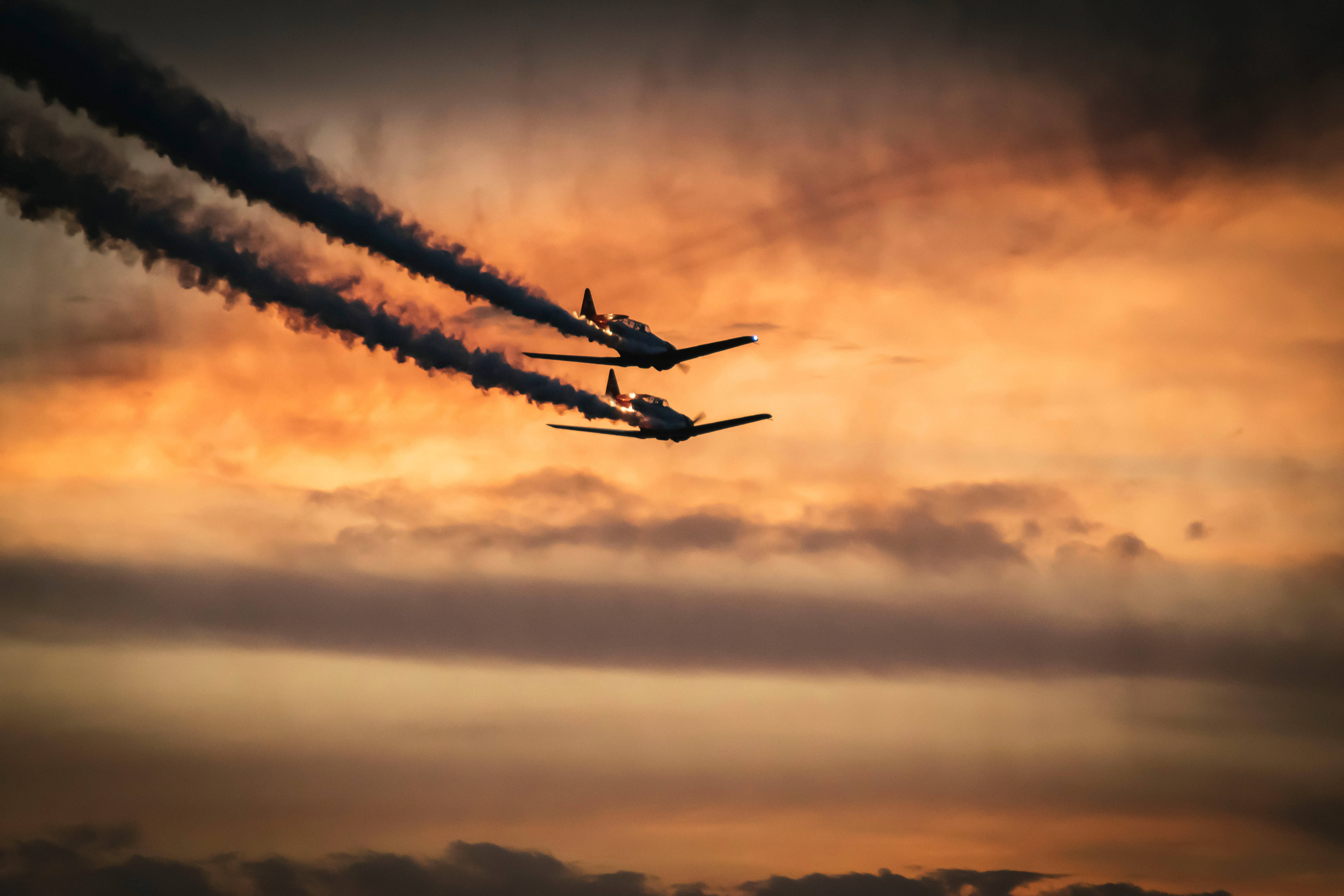vintage fighter jets, fiery sunset sky, thick black smoke, 5K Desktop Wallpaper