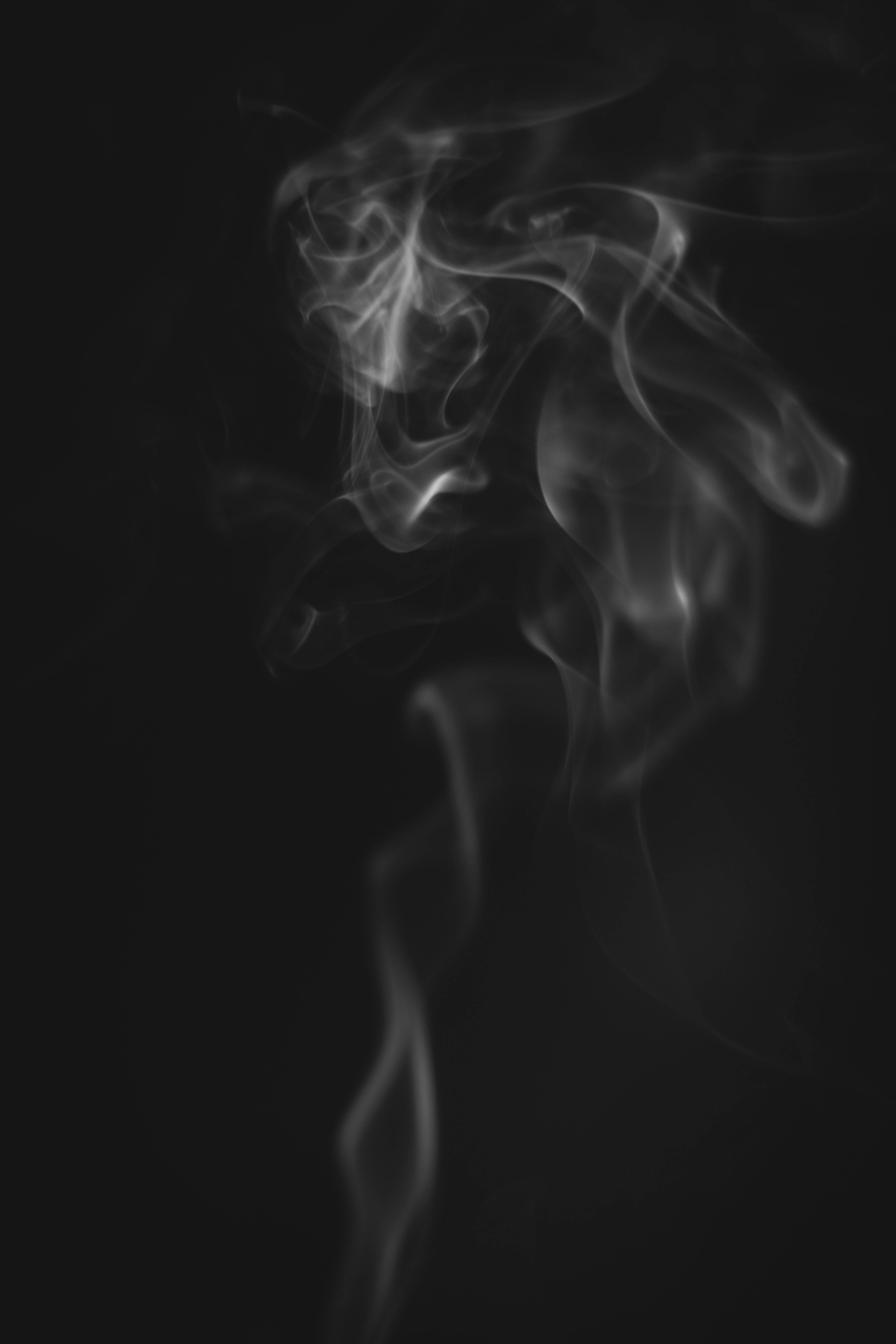 fading rising smoke, ethereal wisps of smoke, deep black background, 5K Phone Wallpaper