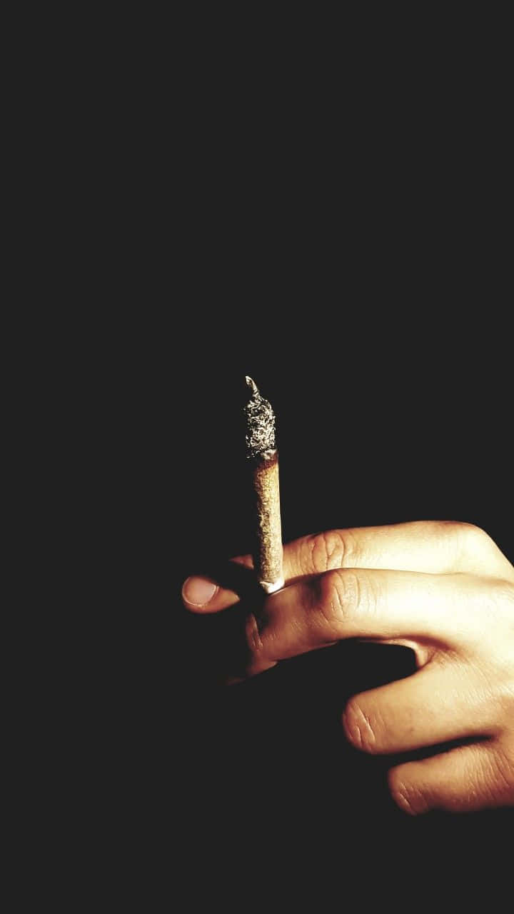 smoked end of joint, lit cigarette, stark black background, HD Phone Wallpaper