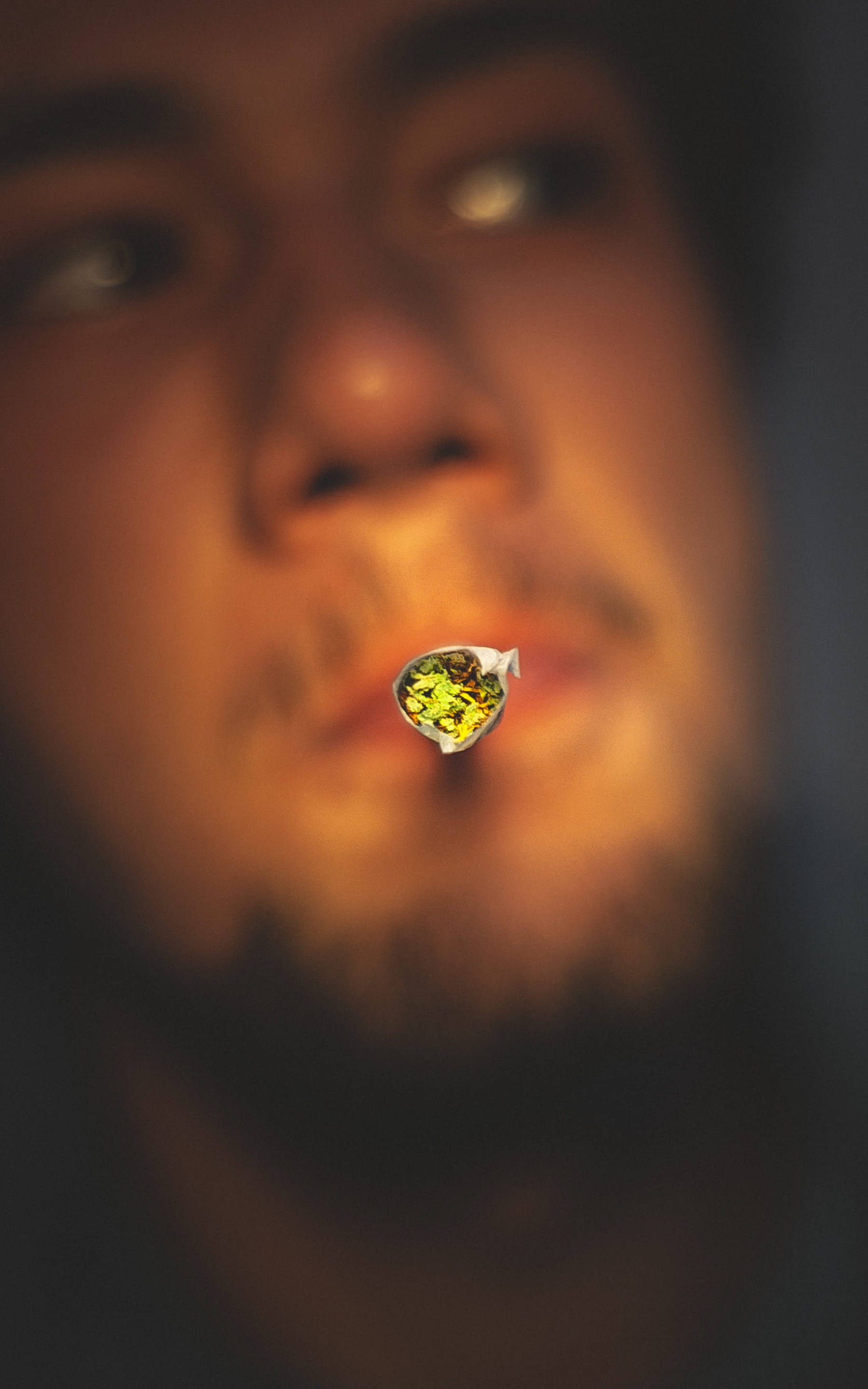 cannabis joint, lit, shallow depth of field, 2K Phone Wallpaper
