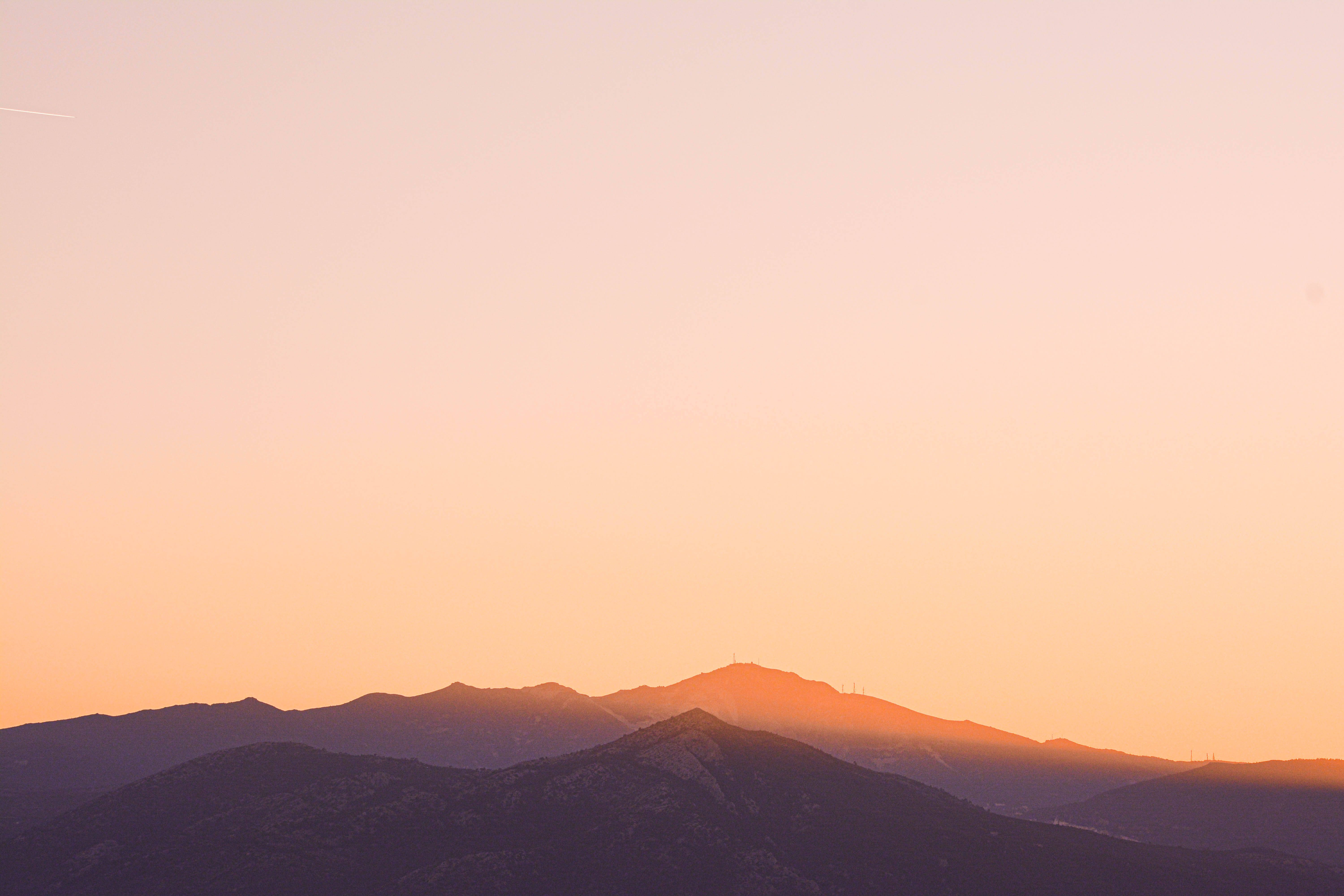 mountain range, sunset, warm orange glow, 5K Desktop Wallpaper