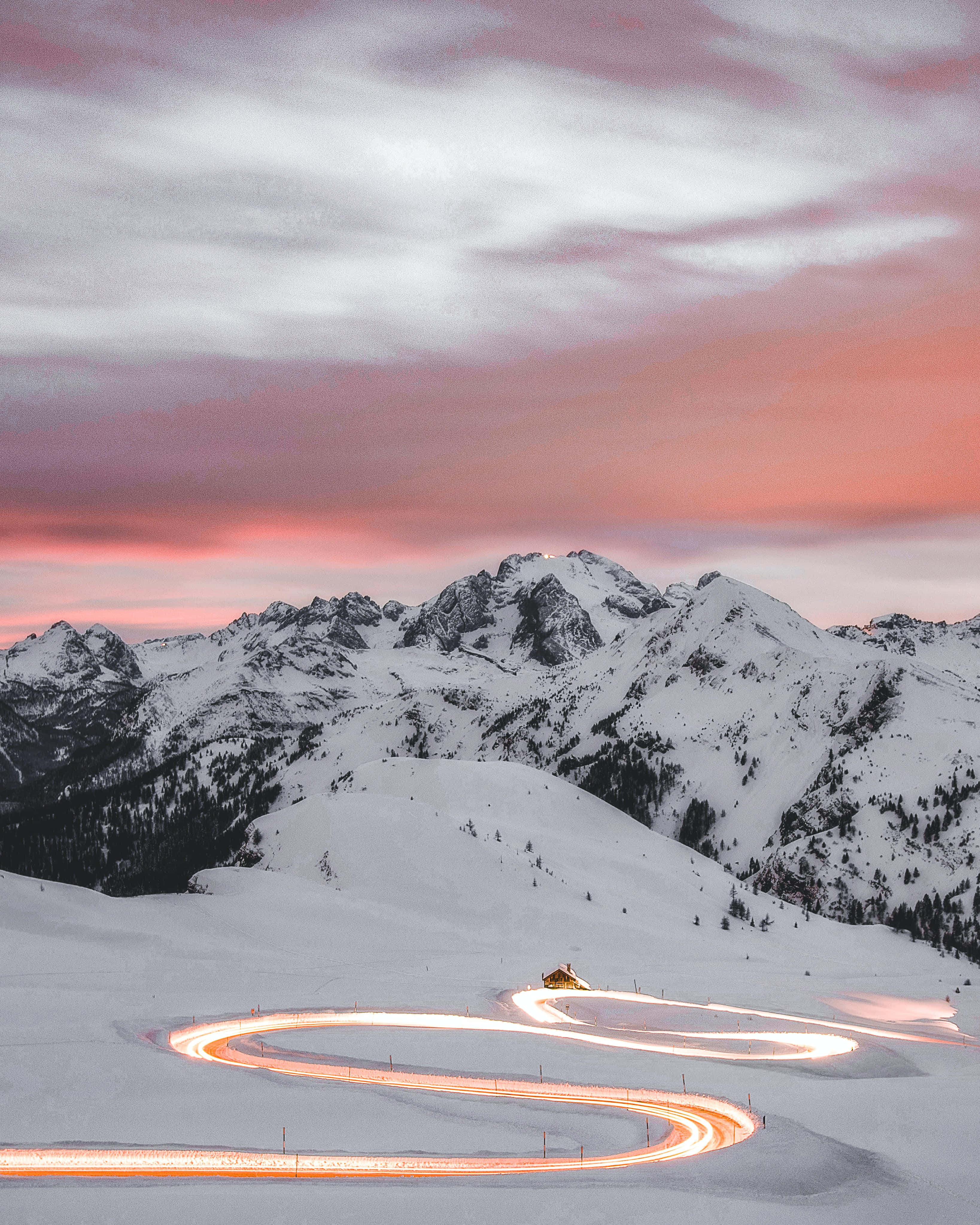 winding snowy mountain road, car light trails, pink and gray twilight sky, 4K Phone Wallpaper