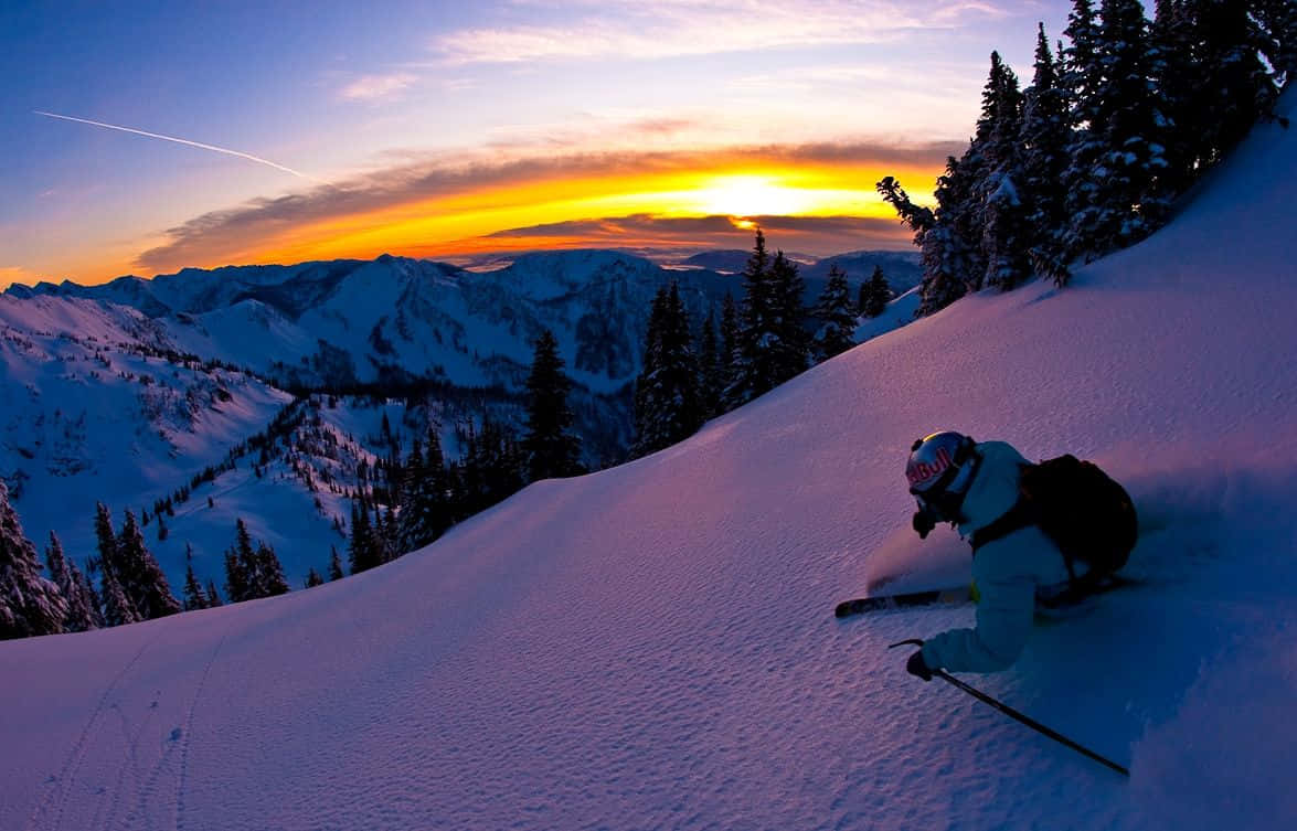skier, snowy mountain slope, sun sets behind distant peaks, SD Desktop Wallpaper