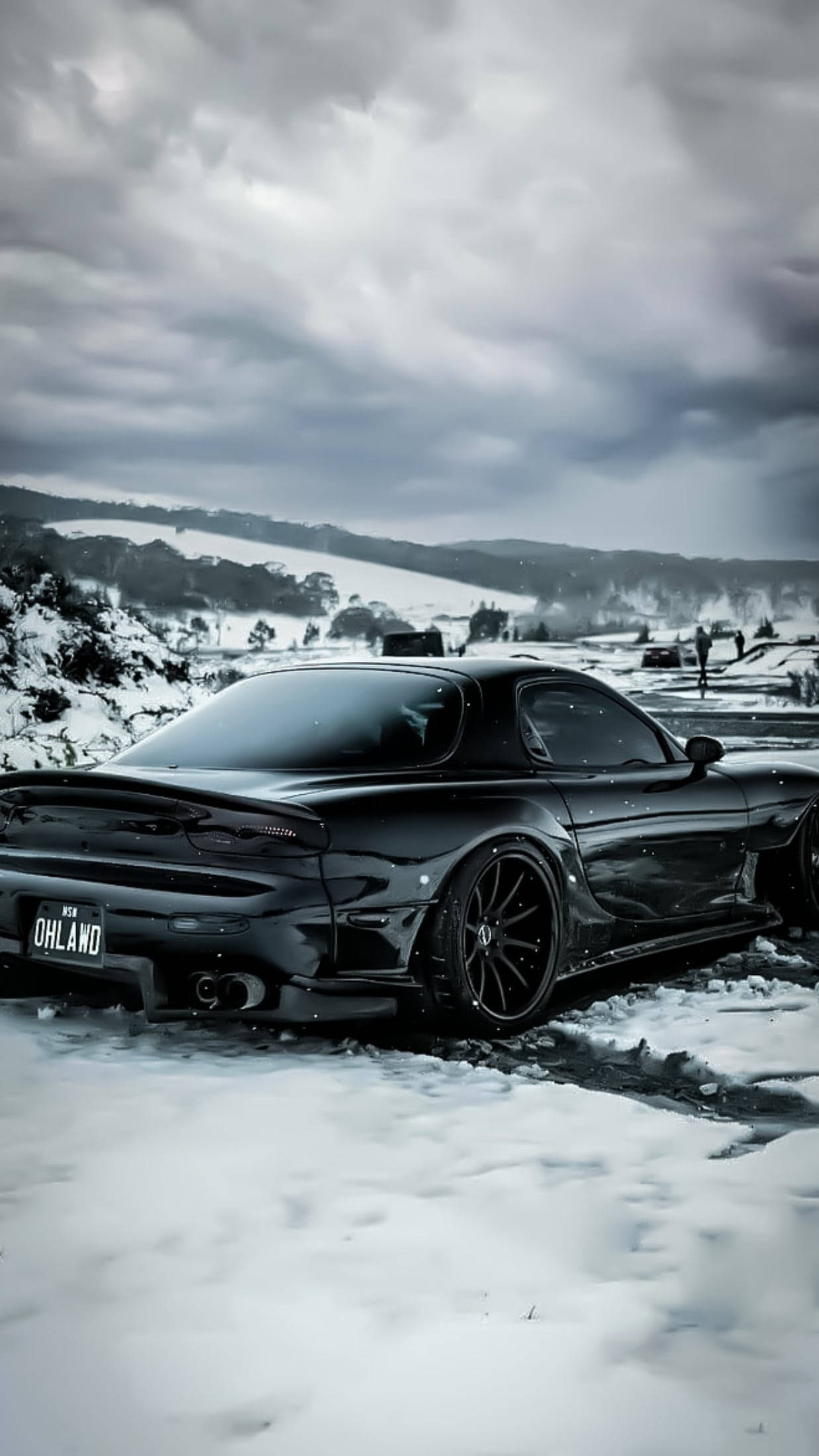 sleek black Mazda RX7, snowy field, dramatic overcast sky, Full HD Phone Wallpaper