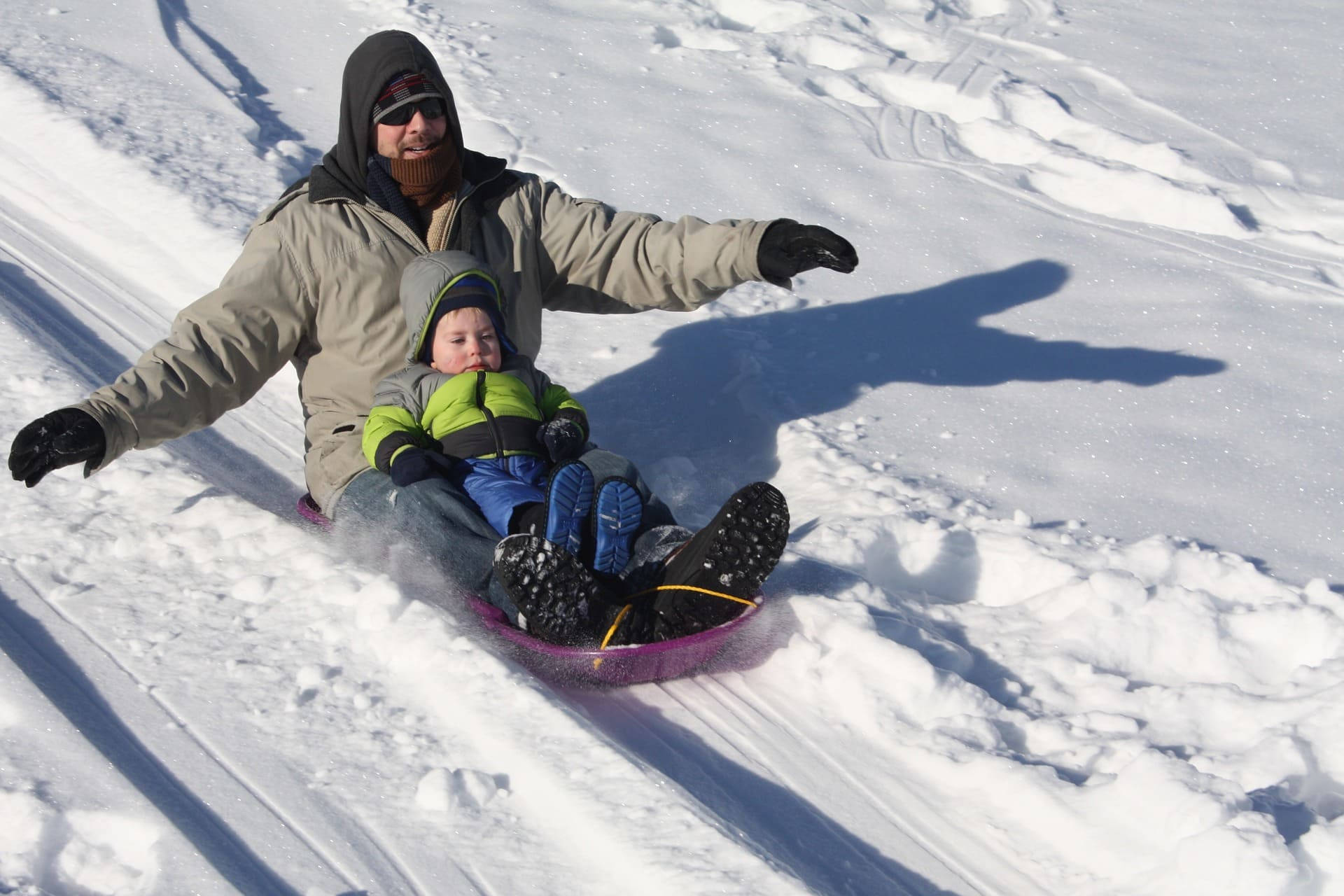 father and son, sledding, sunlit snowy hill, Full HD Desktop Wallpaper