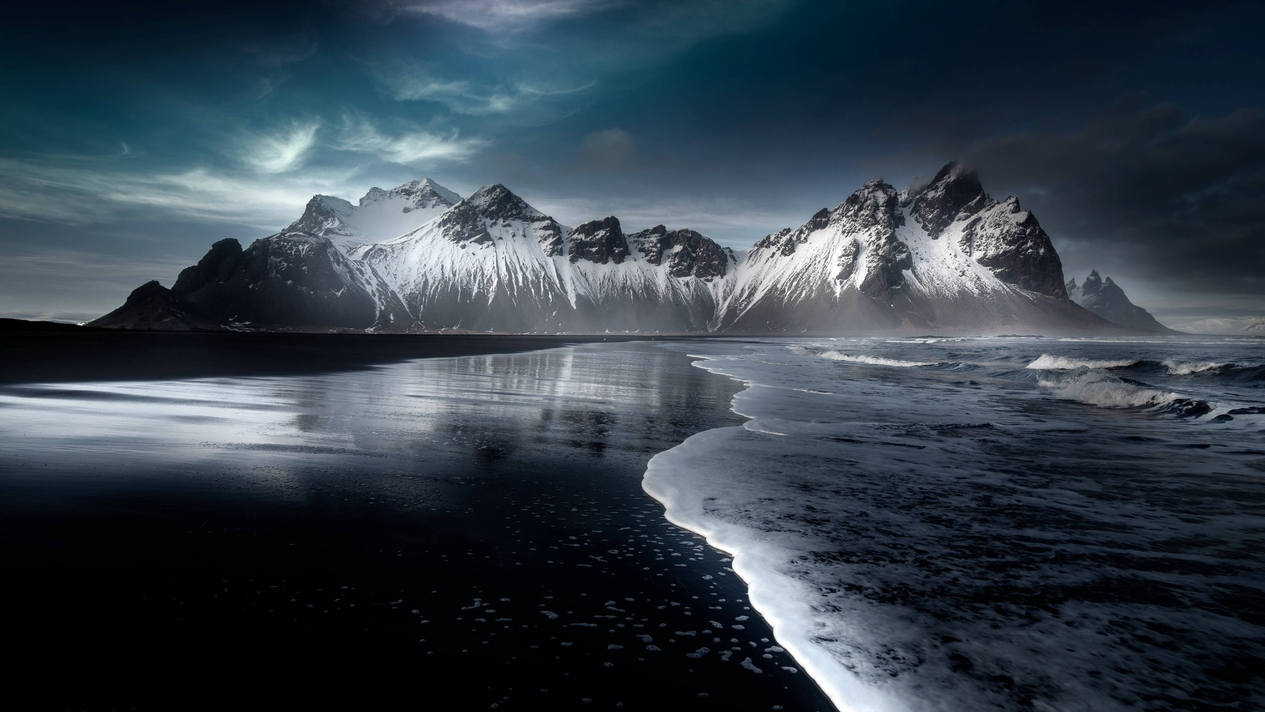 snowcapped jagged mountains, black volcanic beach, moody twilight sky, 2K Desktop Wallpaper