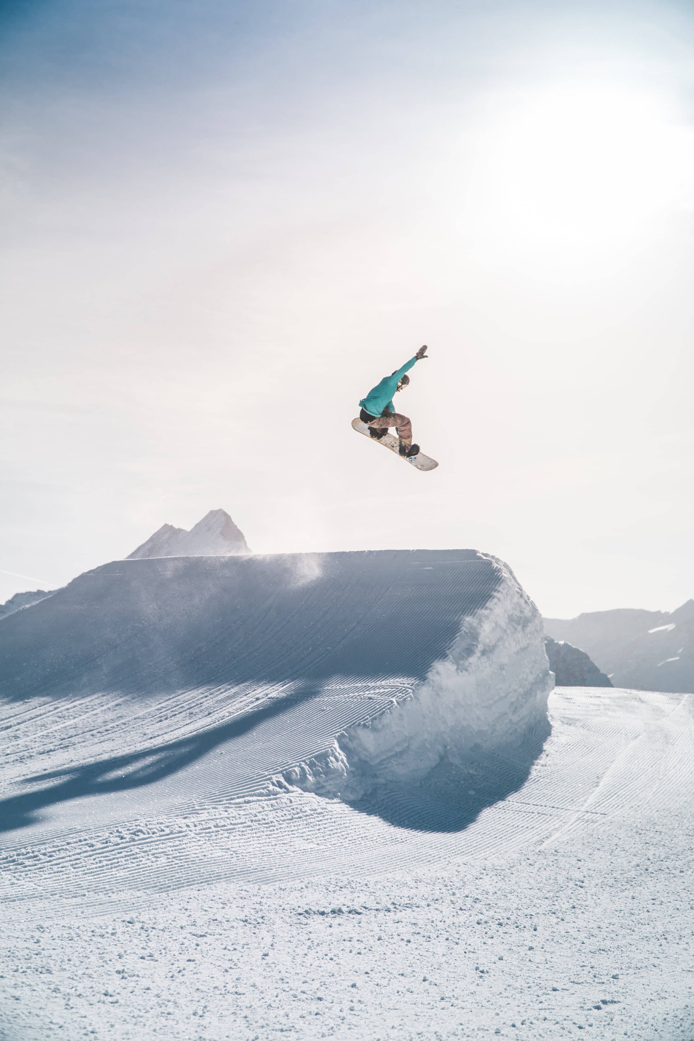 snow-covered ramp, snow-covered mountain, bright winter sky, 2K Phone Wallpaper